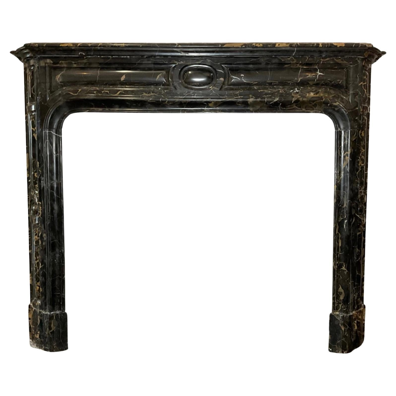 This exquisite French Porto Nero Marble Mantel was crafted in the 1870s and is sure to add a touch of elegance to any room. Its black porto nero marble is of the highest quality, this mantel is sure to last for generations. Enjoy the beauty,