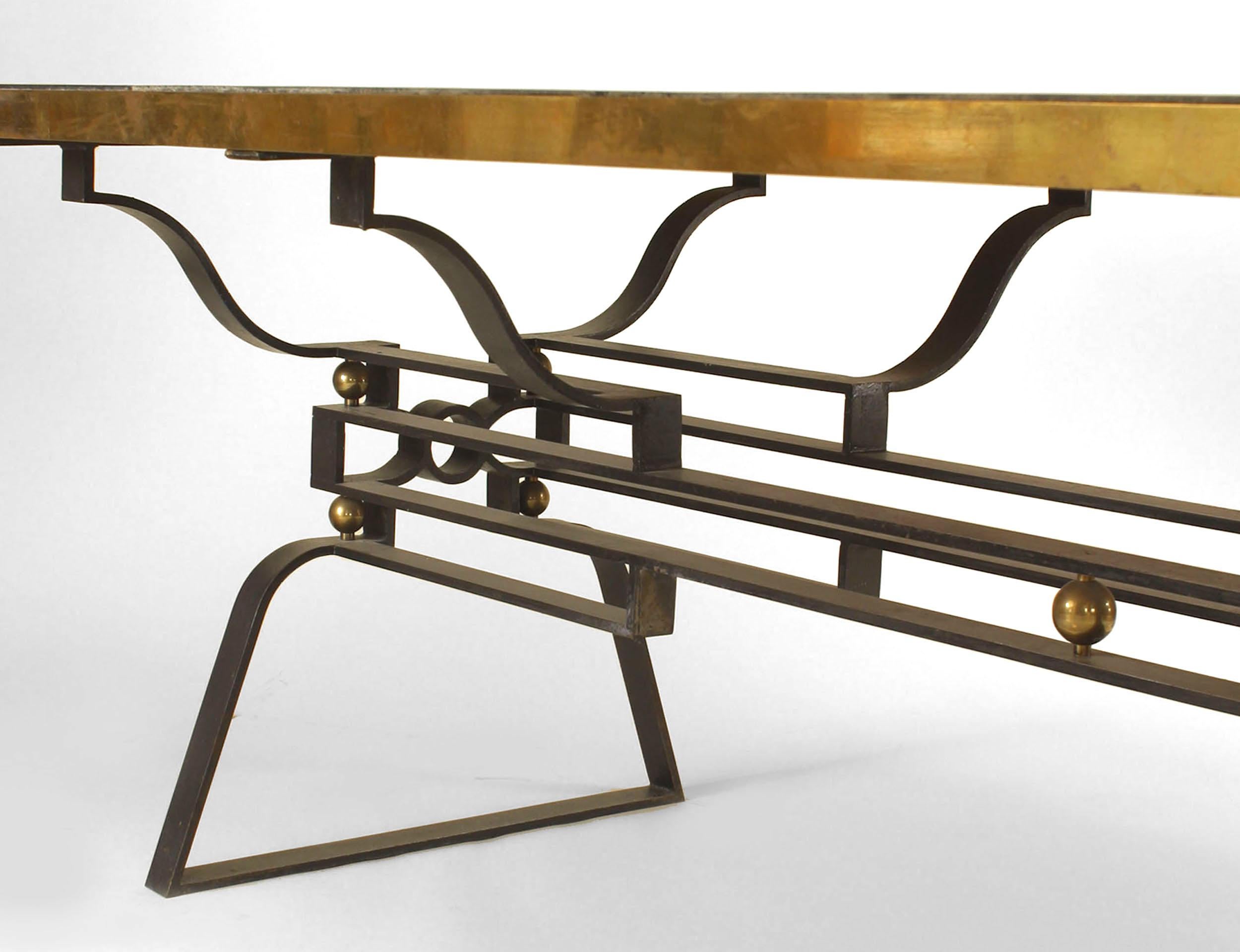 French Post-War Design (1950s) iron dining table with a geometric design stretcher and trimmed with bronze balls and top rim with sectioned inset black marble. (Attributed to GILBERT POILLERAT)
