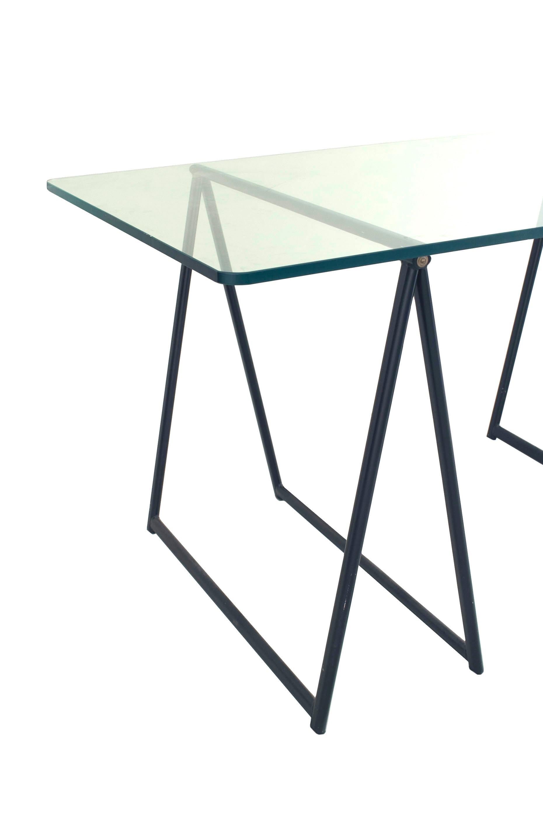 French Campaign style Post-War Design sawbuck design table desk with 2 ebonized metal bases supporting a rectangular glass top. (attributed to JANSEN)
