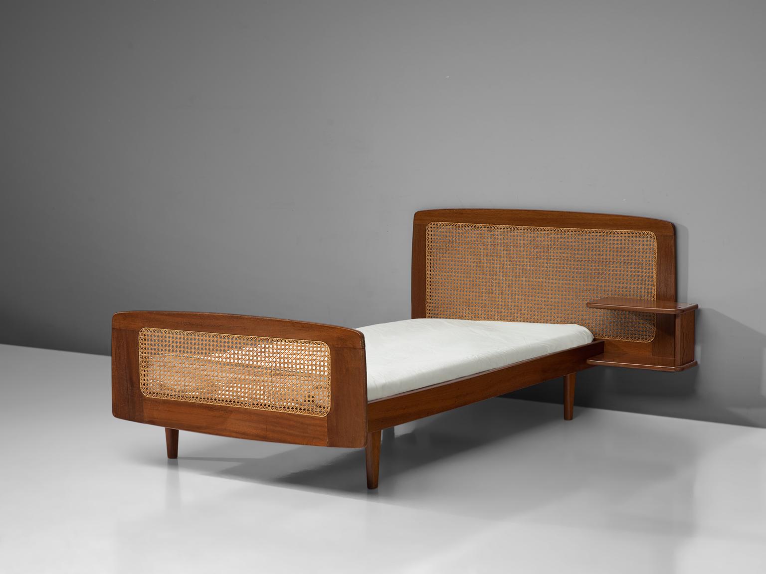 Attributed to Roger Landault, single bed, mahogany and cane, France, 1950s

French Post-War reconstruction single bed attribute to Roger Landault. The bed is made of mahogany and features a headboard and footboard made with cane. Shelves are