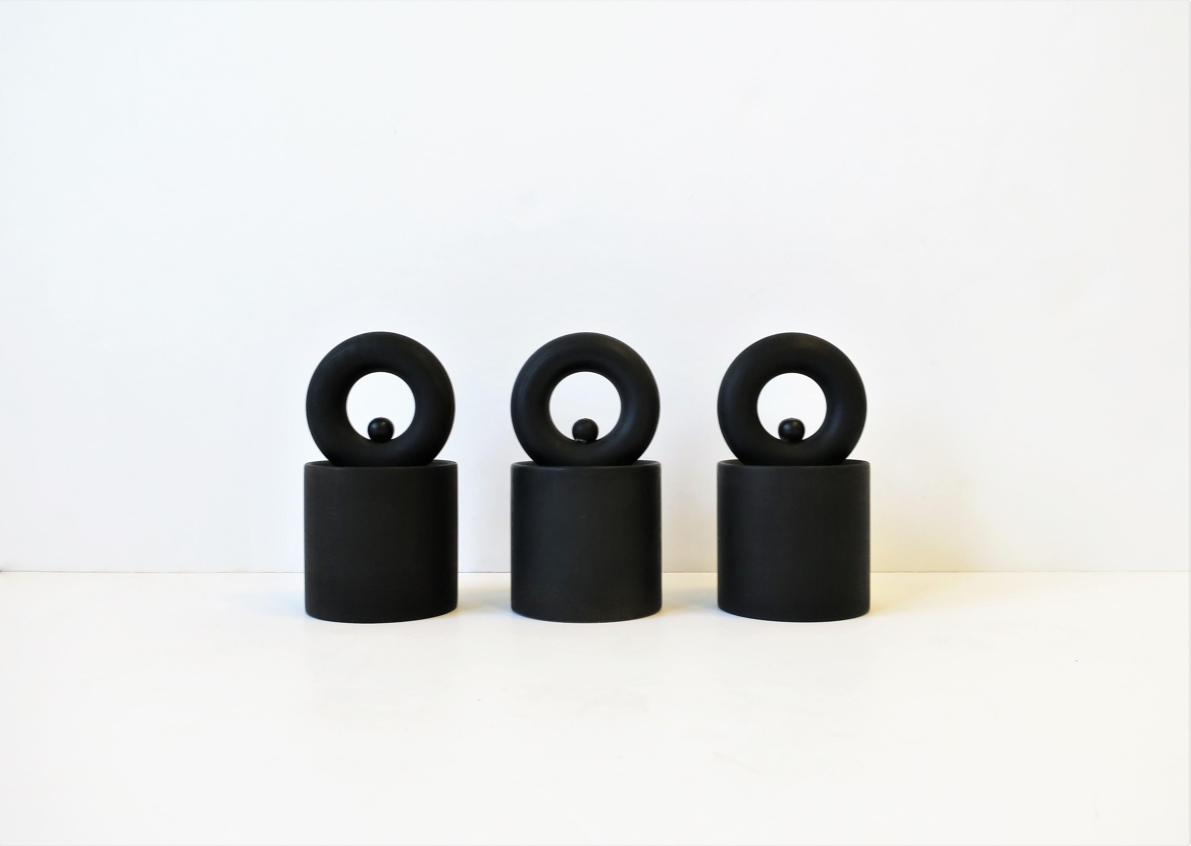 A beautiful set of three (3) French Peugeot designed matte jet black Postmodern salt and pepper sculpture mills, circa late 20th century, France. These beautifully designed sculpture mills are each marked 'PEUGEOT', 'Made in France', on bottom as