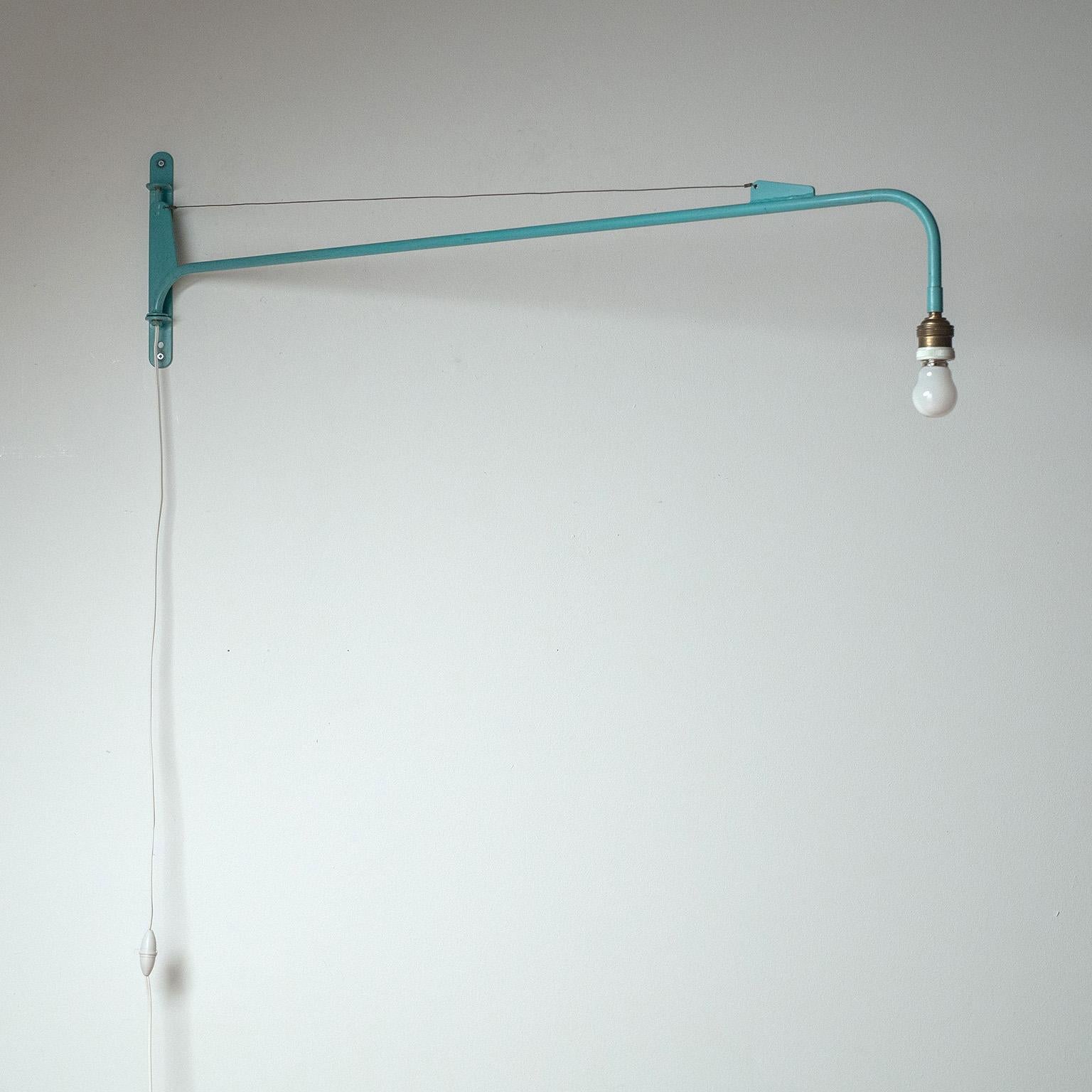 Classic Jean Prouvé French potence swing lamp from the 1950s. Turquoise painted iron and a swing mechanism that allows for effortless 180º movement. The design and dimensions of the backplate and other elements are identical to those produced by the