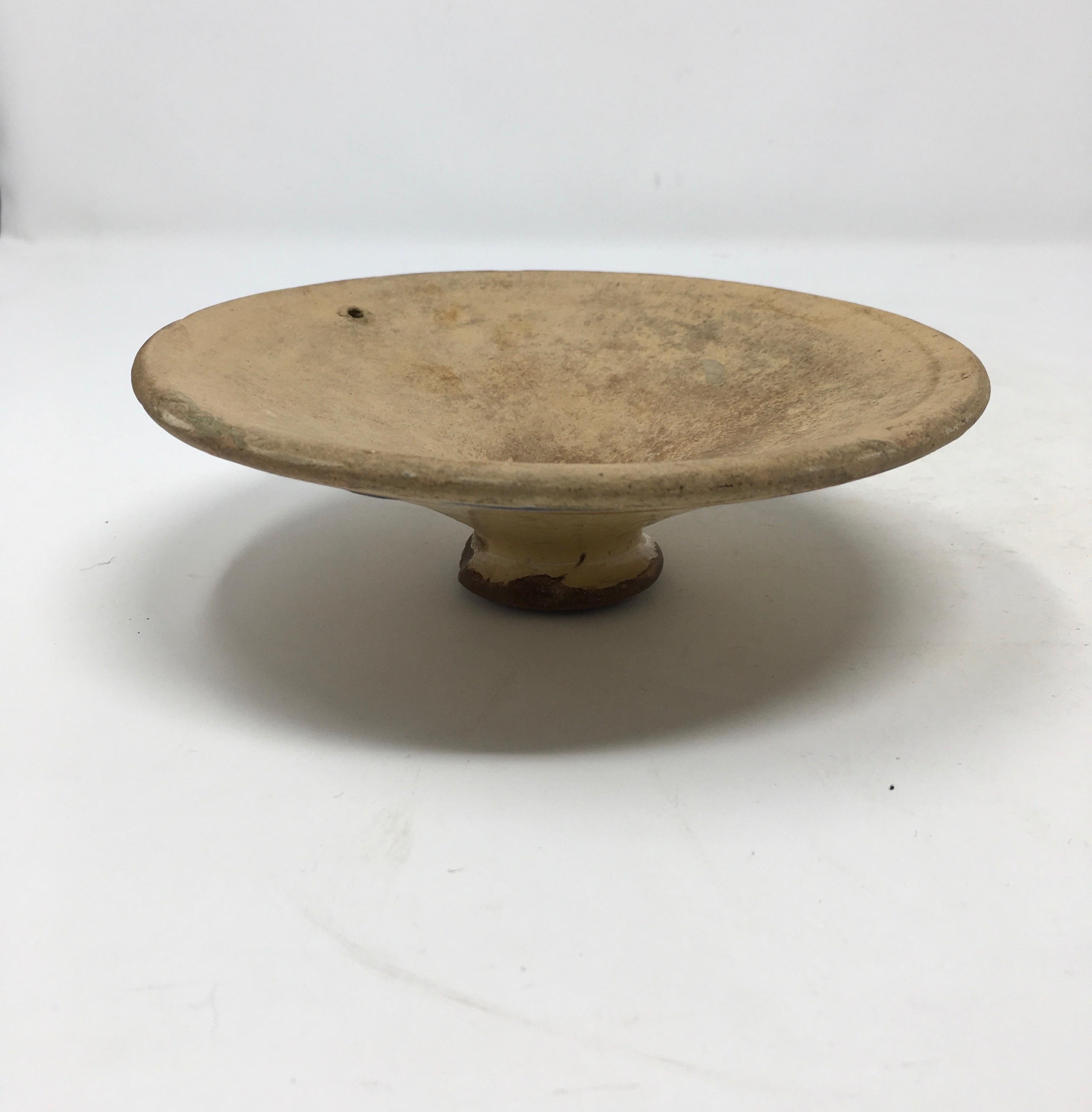 This unusual saucer or lid would make a nice compliment to a kitchen display. While it stands freely we are not sure if it was ever used on its own or was a lid to another piece which we do not have. Picture it placed on a stack of cookbooks!