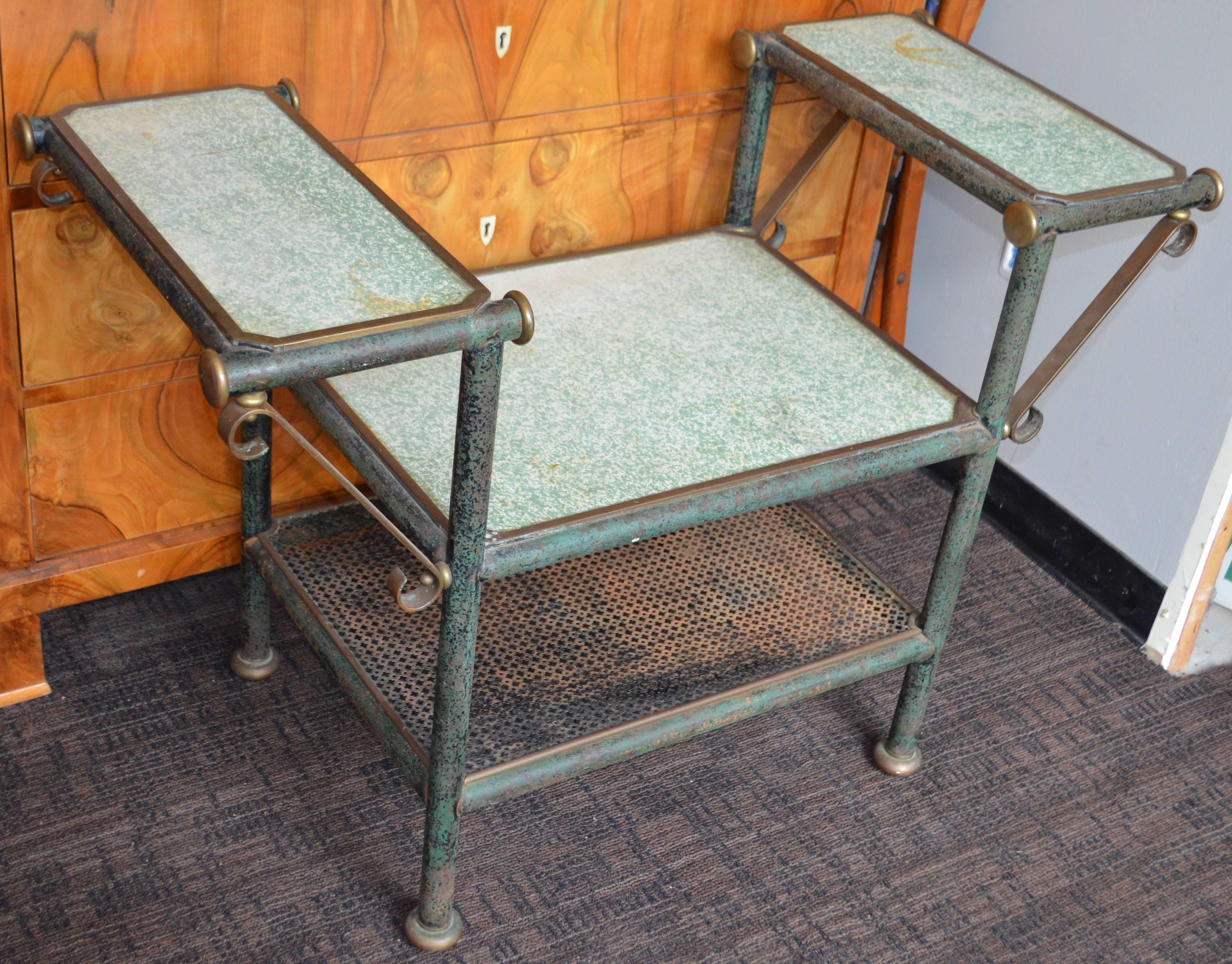 French, four-tier potting table, floral display, circa 1940. From Parisian florist shop. Heavy-duty iron frame with bronze trim and formica work counters. The iron has a subtle paint patina. Steel mesh shelf beneath is removable. Heavy duty,