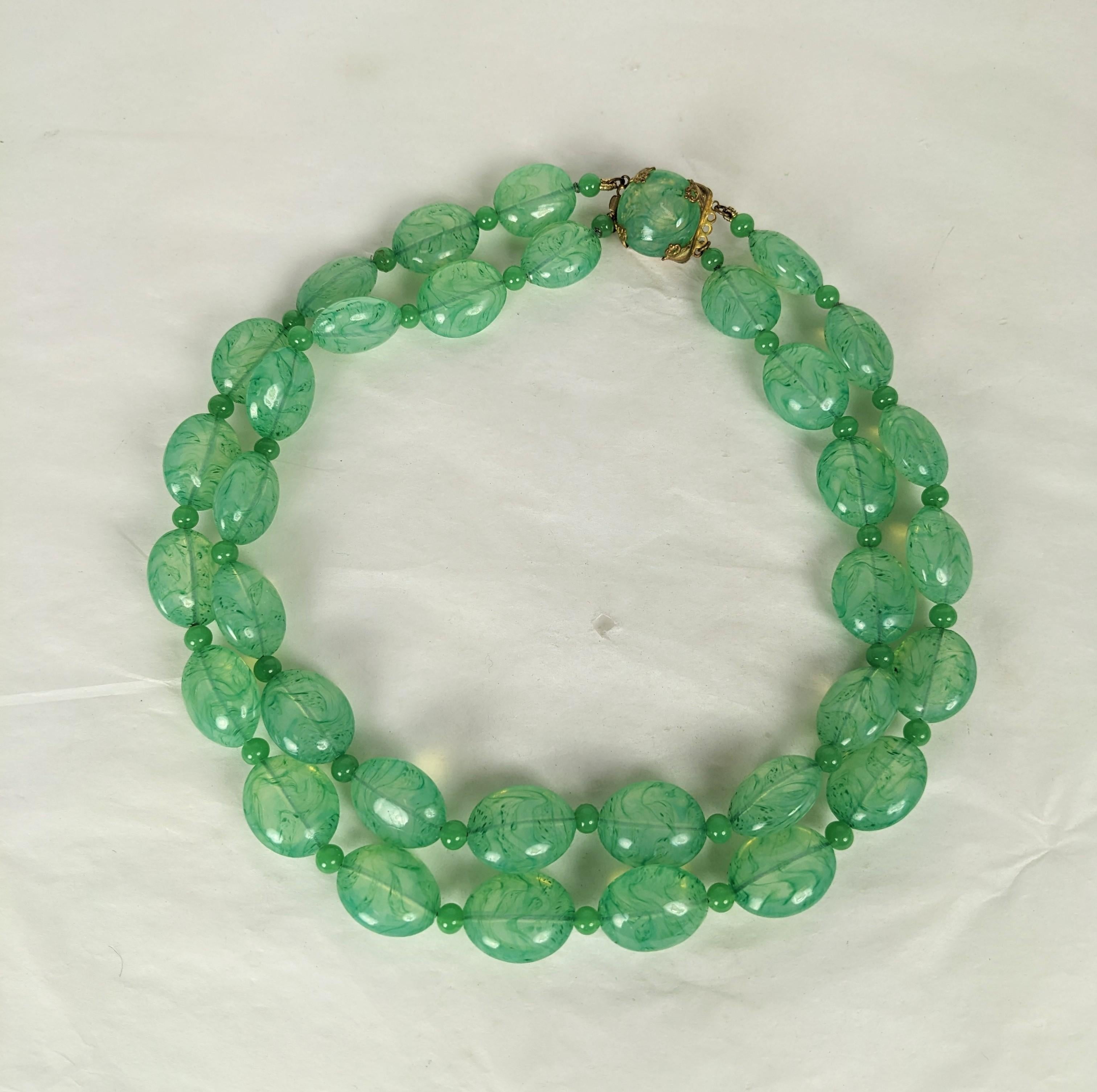 French Poured Glass Faux Jade Beads from the 1950's.  Double strand with hand made mottled Gripoix glass beads and spacers in variegated jade tones with gilt filigree clasp.  17.5