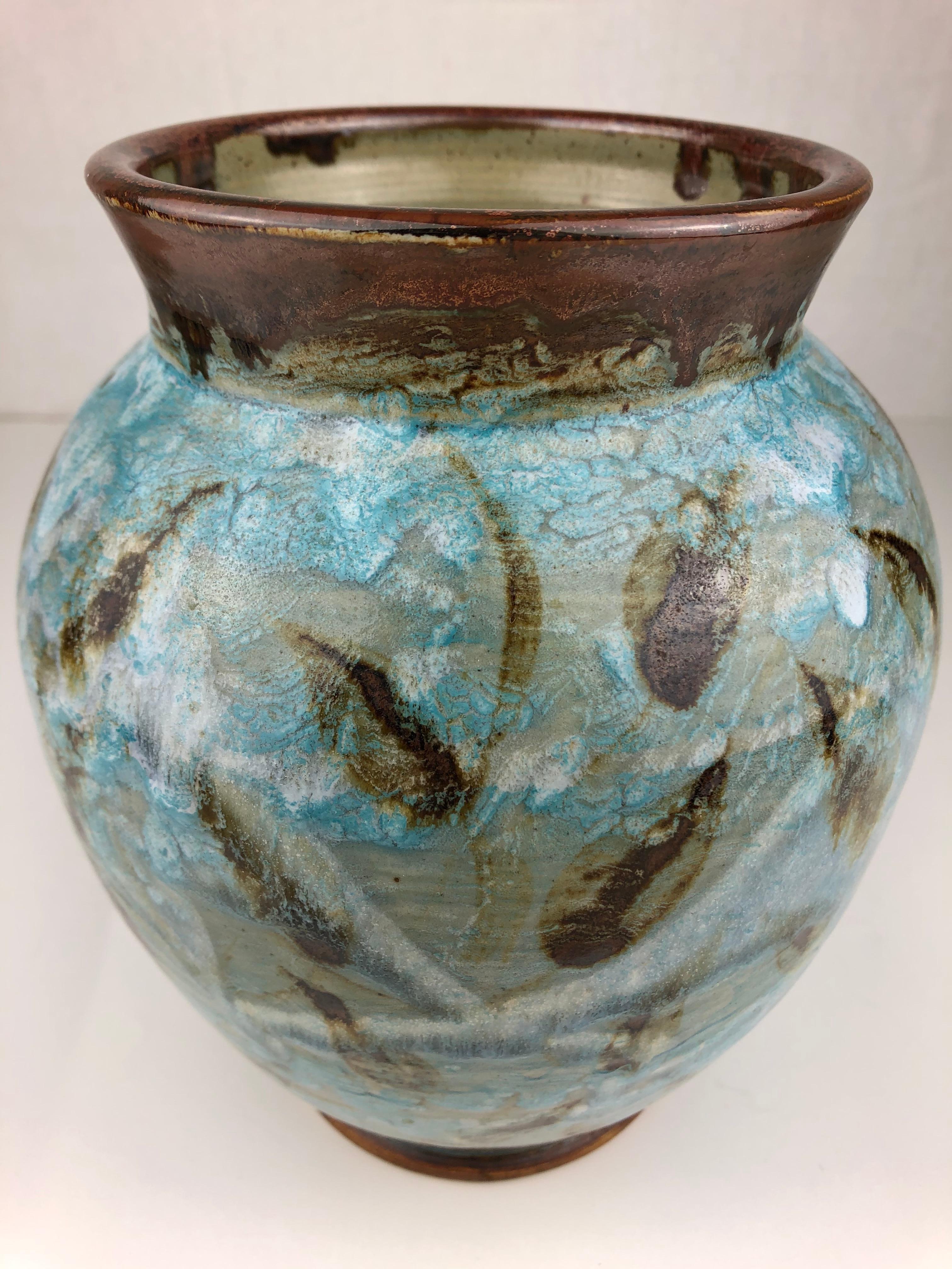 This dazzling glazed ceramic vase was handcrafted in France, circa 1980-1990 by Gerard Rappa. The mixture of colors are truly beautiful and the aquatic plants add to the charm.  

It can enhance any shelf, table, credenza or countertop as it is