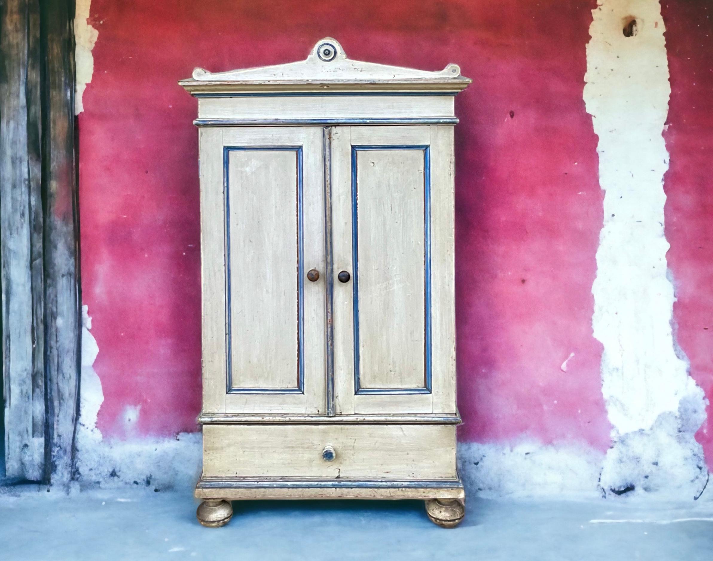 This is such a sweet piece! It is a diminutive antique French blue and white painted armoire. It has almost a child’s scale, which is why it might also work as a wall mounted piece. See the photo where I have edited the feet out. It is in very good