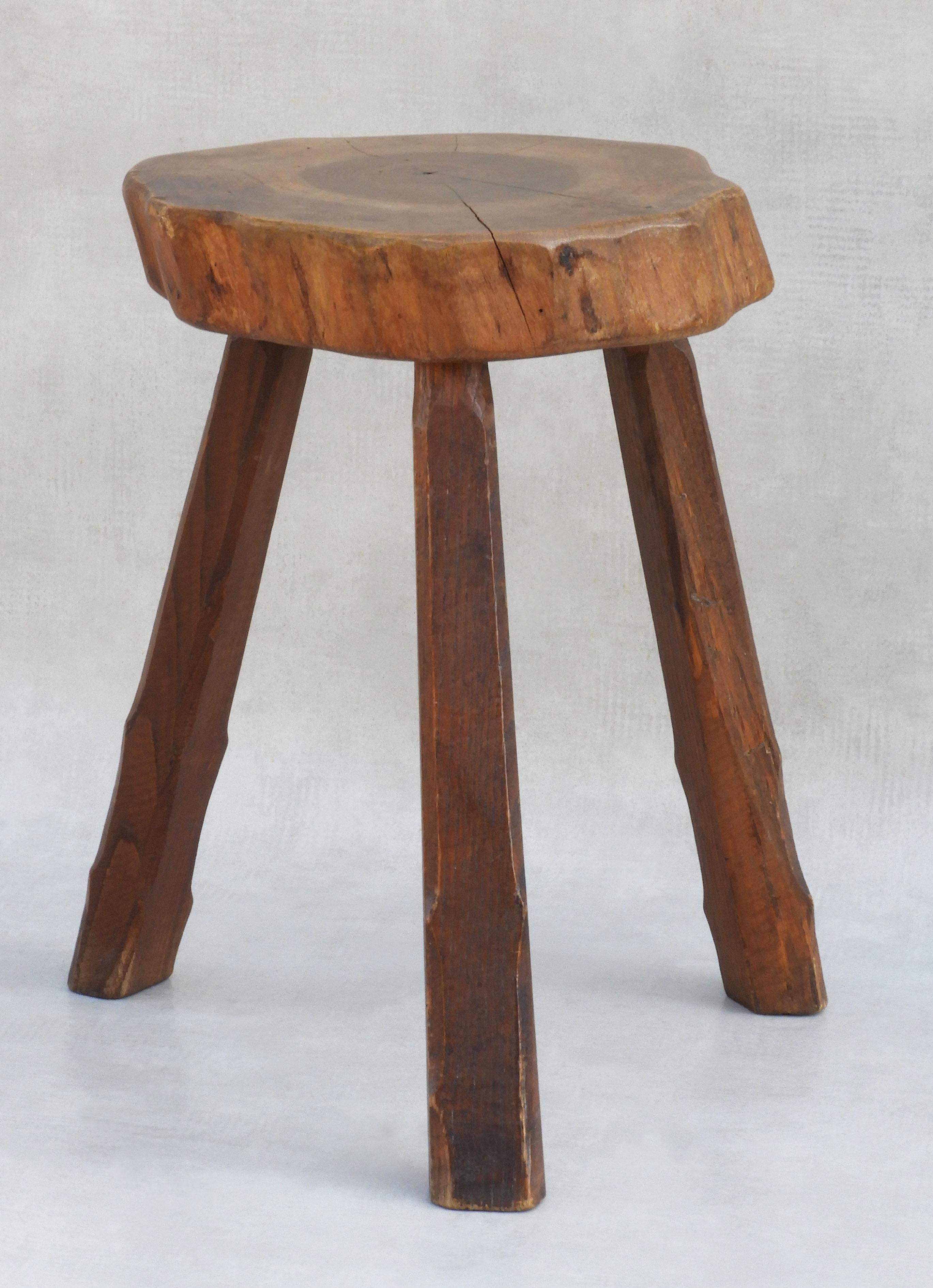 Primitive three-legged tabouret stool handcrafted in France, circa 1950. Well made, solid and sound with no hardware. Live edge, good grain, great patina. A really nice example of mid-century handcrafted French 'Arte Populaire' in great vintage