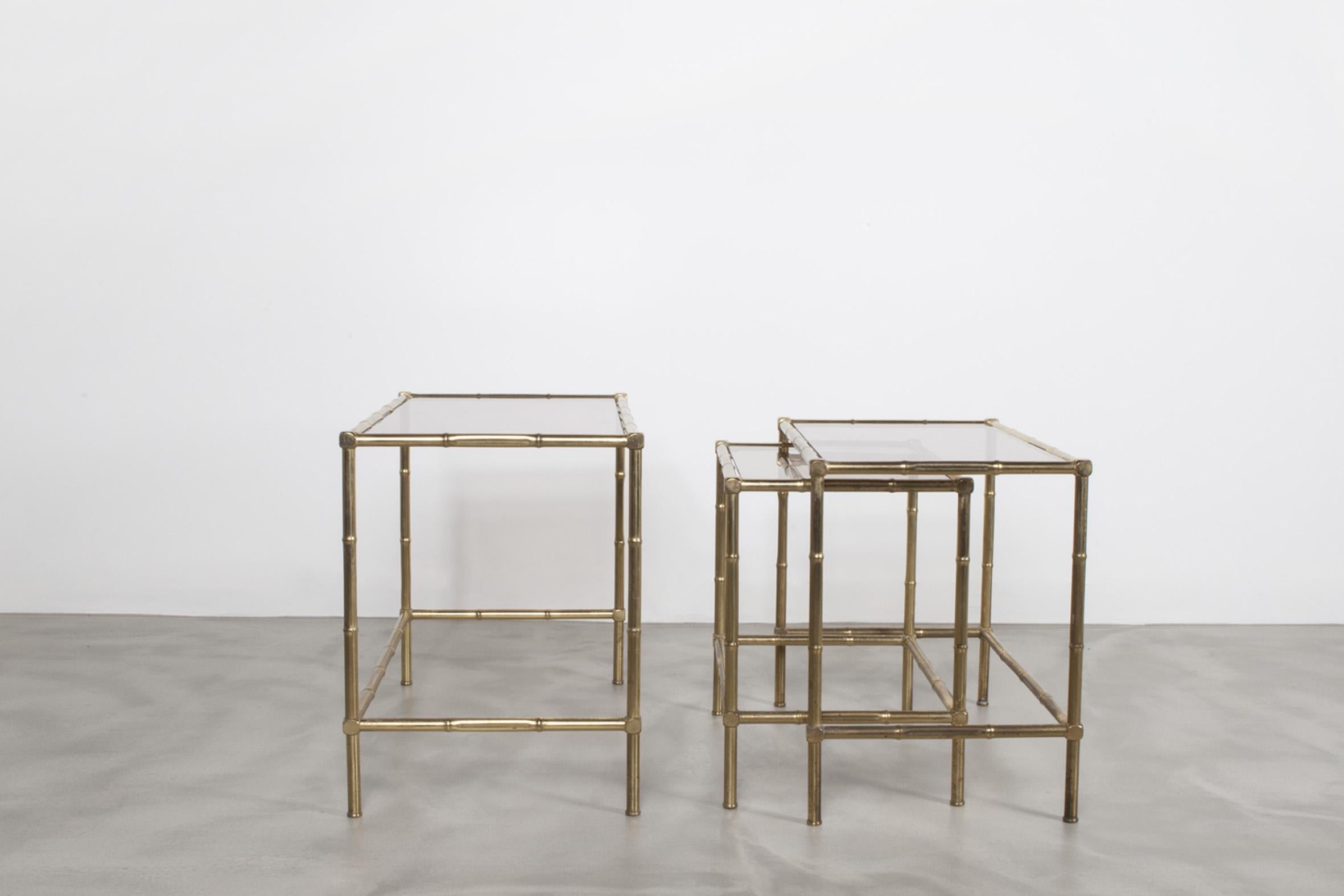 Set of three nesting tables in patinated brass metal with stylized hand-forged bamboo design.