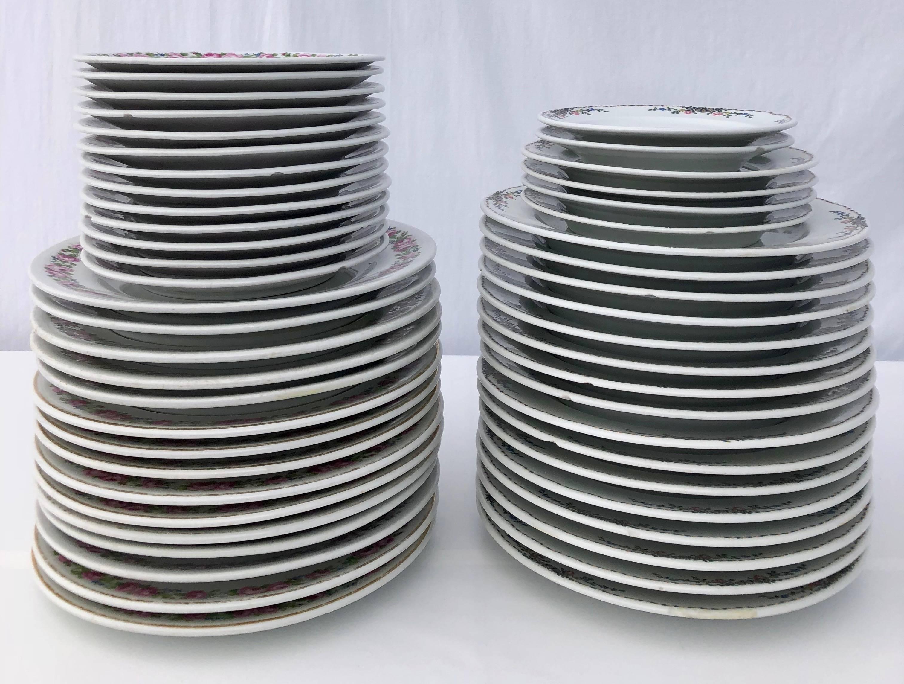 This is a set of 50 French plates by Havilland and Bernardaud, Limoges. Both sets are white with a floral design. They were used in a famous two Michelin star restaurant in Paris and are made of wicker porcelain, a sturdier porcelain for