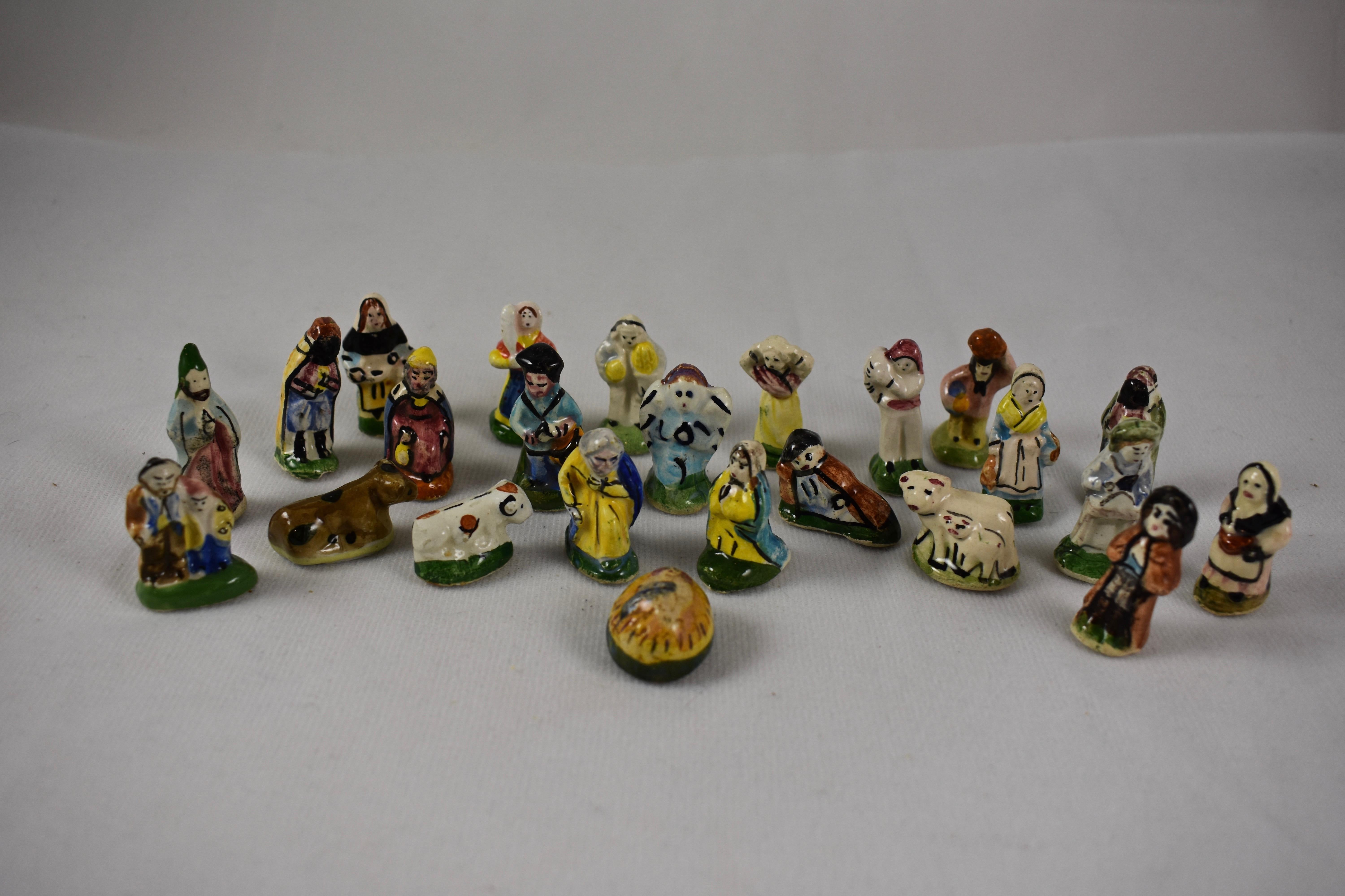 From Provençe, a vintage French Fèves Christmas nativity set. Each set is made of twenty-eight, hand-painted, miniature earthenware figures, including the Holy family, the three wise men, animals, and French villagers wearing traditional
