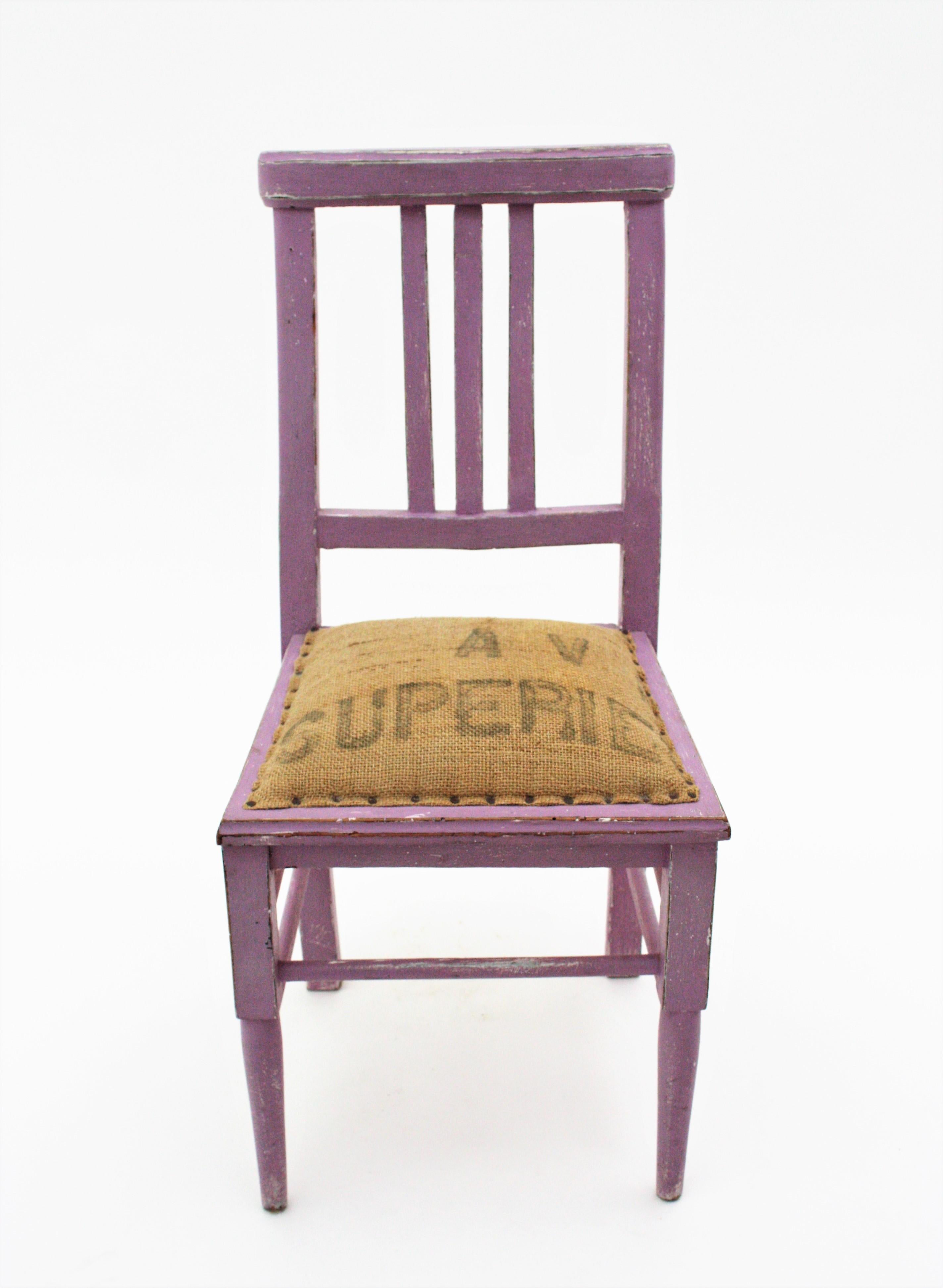 A cool wooden child chair in lavender patina. France, 1940s
This cute chair is handcrafted in wood and painted in lavender color. The seat is upholstered with grain burlap sacks.
It has all the taste of the french Provence.
A good addition to be