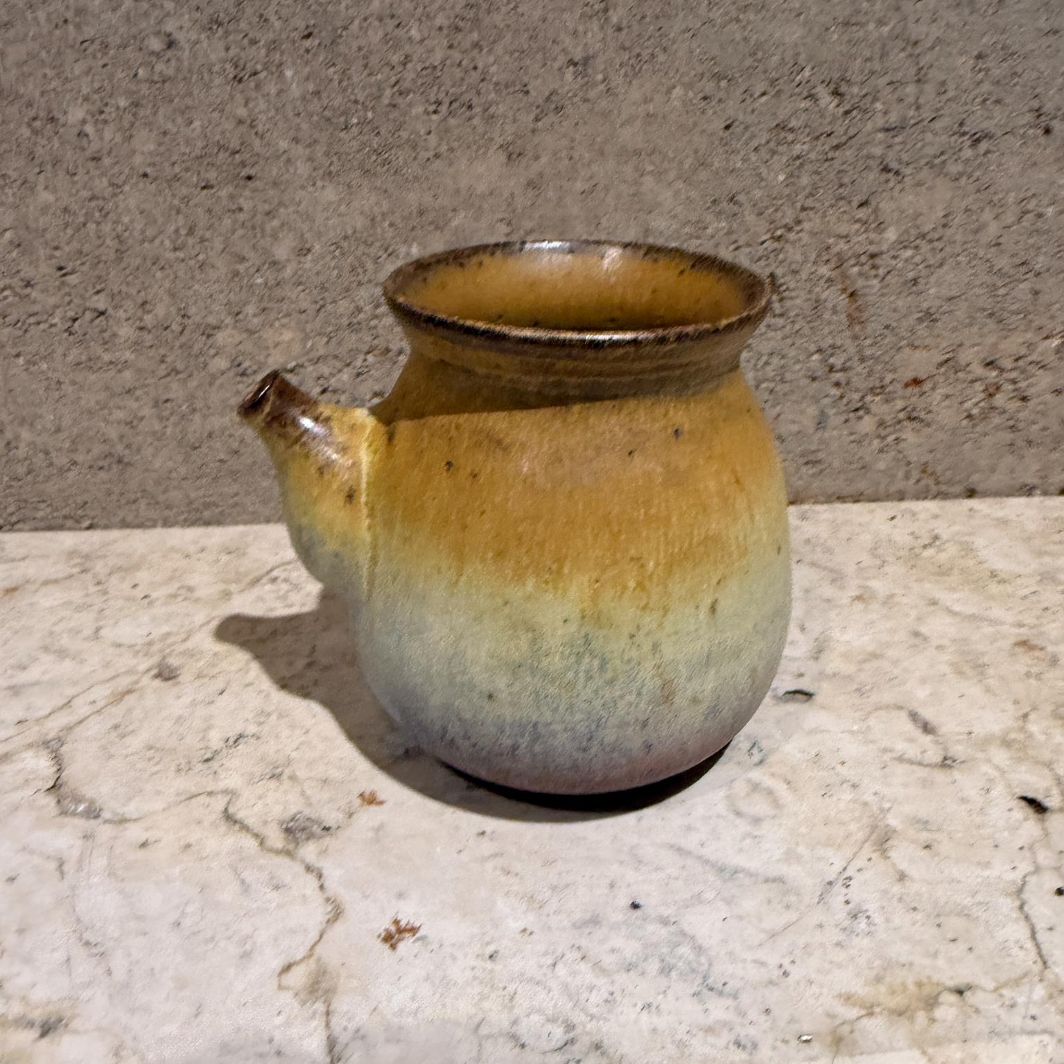 For your consideration a  French provencal stoneware mini pitcher creamer pottery with ochre color. Unique shape, beautiful decorative. Stamped with letter 