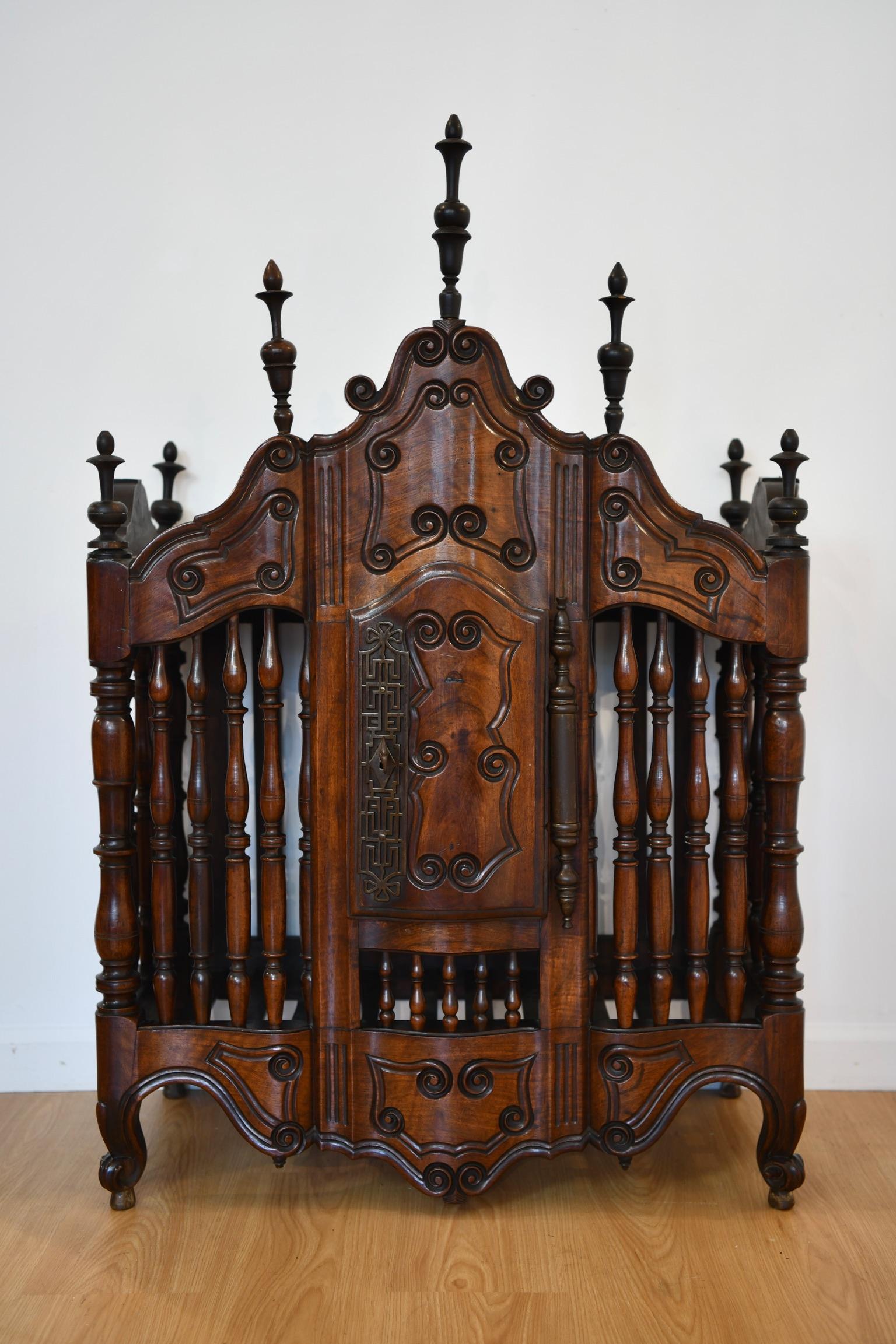 Antique mahogany panetierre with turned spindles, carved details, and original key and lock. Dimensions: 47