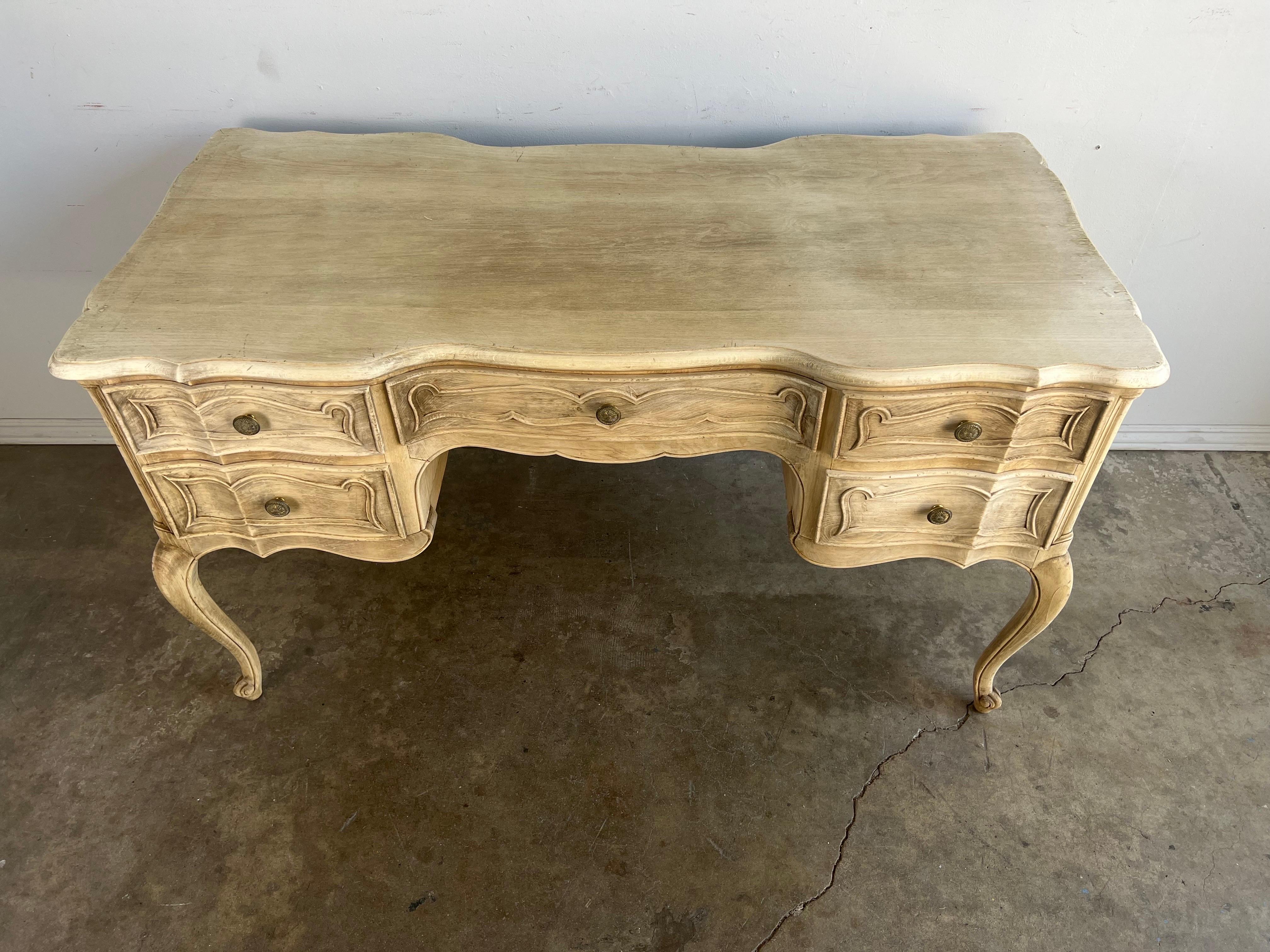 French Provencal style desk standing on four cabriole legs with rams head feet. The desk has five drawers for plenty of storage. Originally cast hardware on drawers.