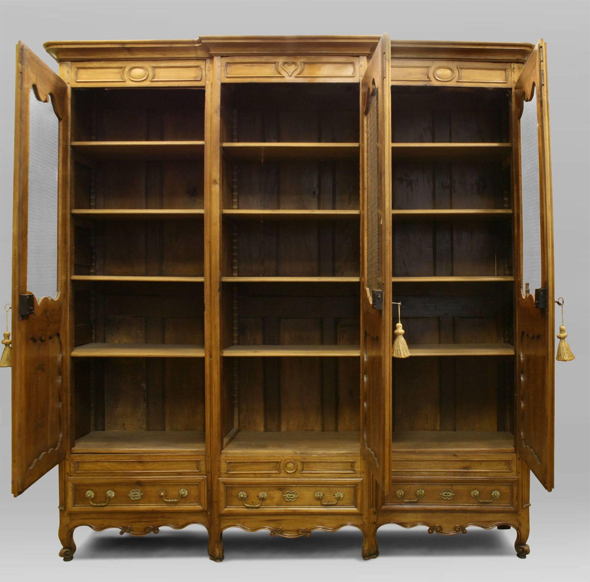 French Provincial (18/19th Century) walnut armoire cabinet with 3 drawers at bottom and doors with wire mesh panels.
