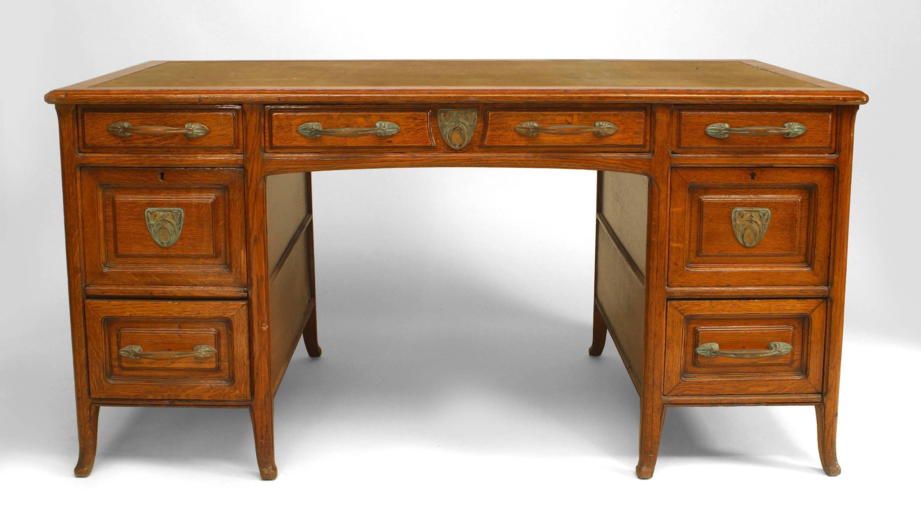 French Provincial (19th century) oak kneehole desk with bronze Art Nouveau hardware and green felt top.
 