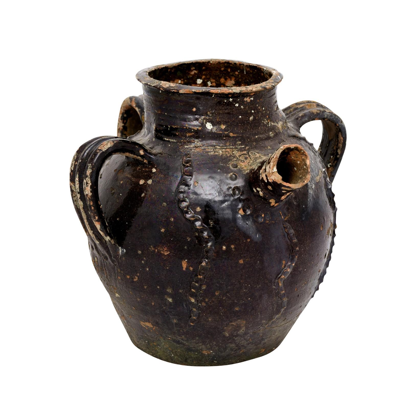 A French Provincial glazed pottery pouring jug from the 19th century, with single spout, three handles and great rustic character. Created in southern France during the 19th century, this pottery jug attracts our attention with its interesting