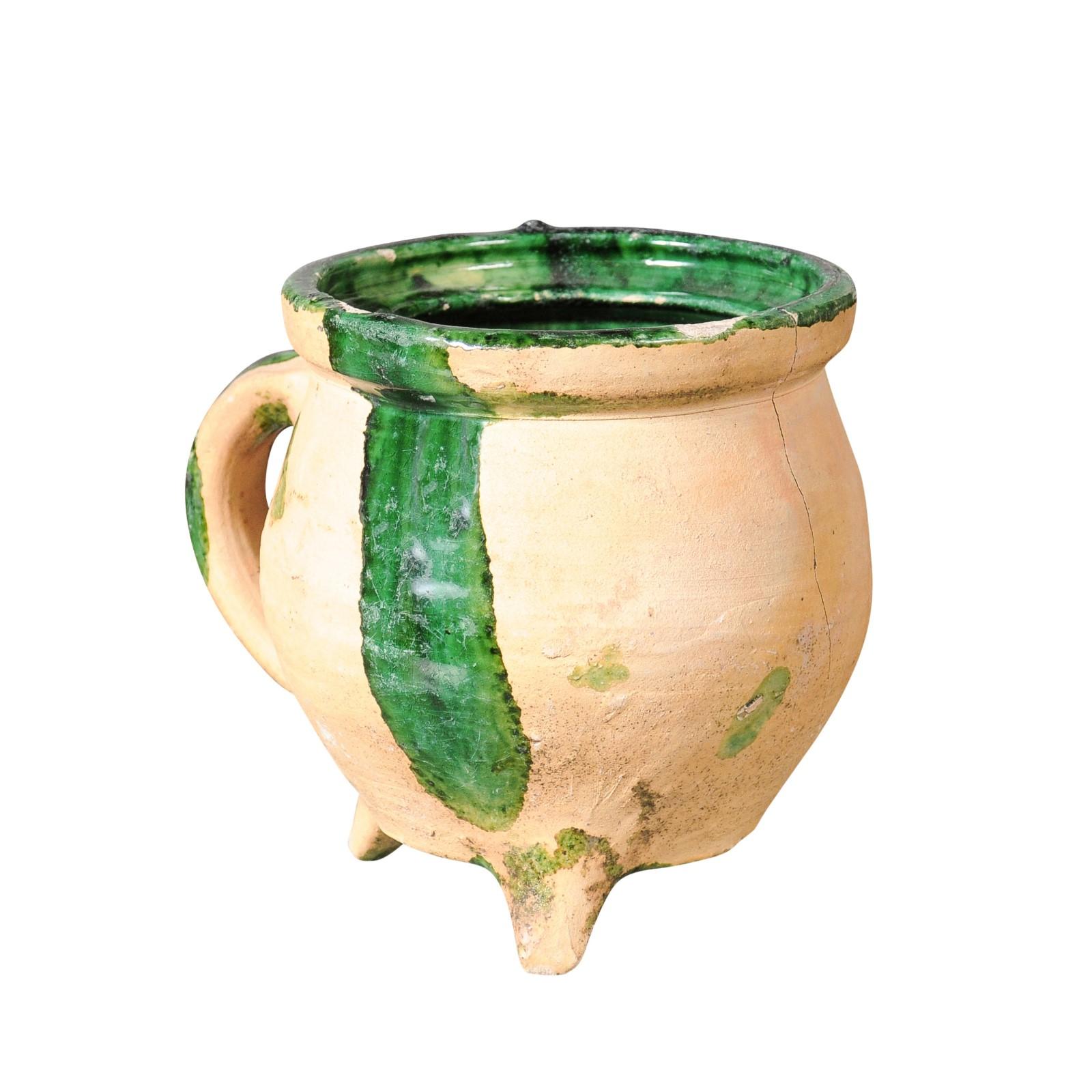 Ein Kochtopf aus französischer Provinzial-Keramik aus dem 19. Jahrhundert mit grün glasierten Akzenten, geformtem Henkel und Dreibeinfuß. Dieser im 19. Jahrhundert in Südfrankreich hergestellte Kochtopf hat eine runde Öffnung, die mit einer grünen