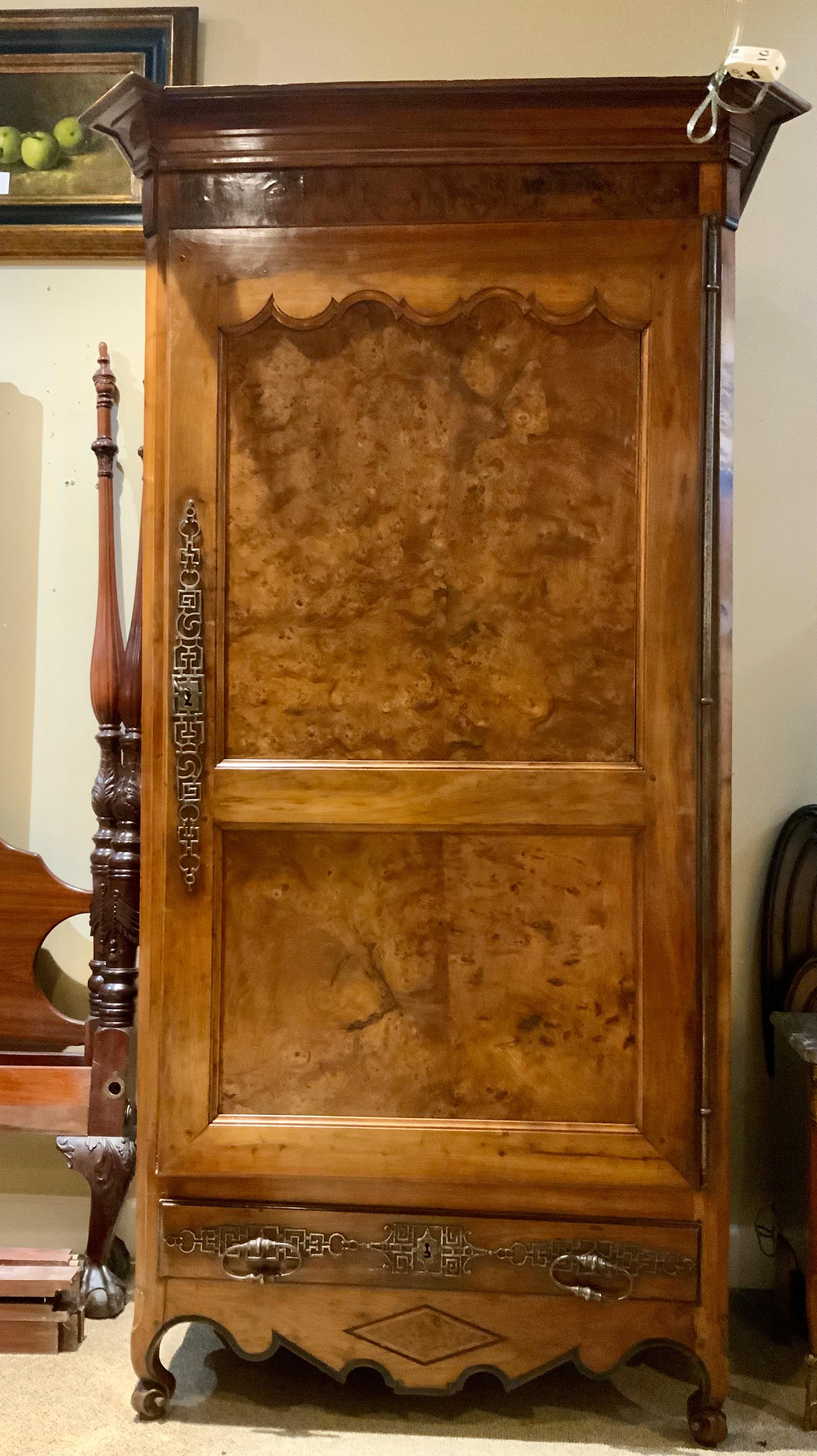 This bonnetiere/armoire is made of burled walnut and fruitwood 
It has long full length hinged door that opens to two
Shelves. Shelves are easily removable if you prefer
To add a rod for hanging garments. It has one drawer
At the bottom that slides
