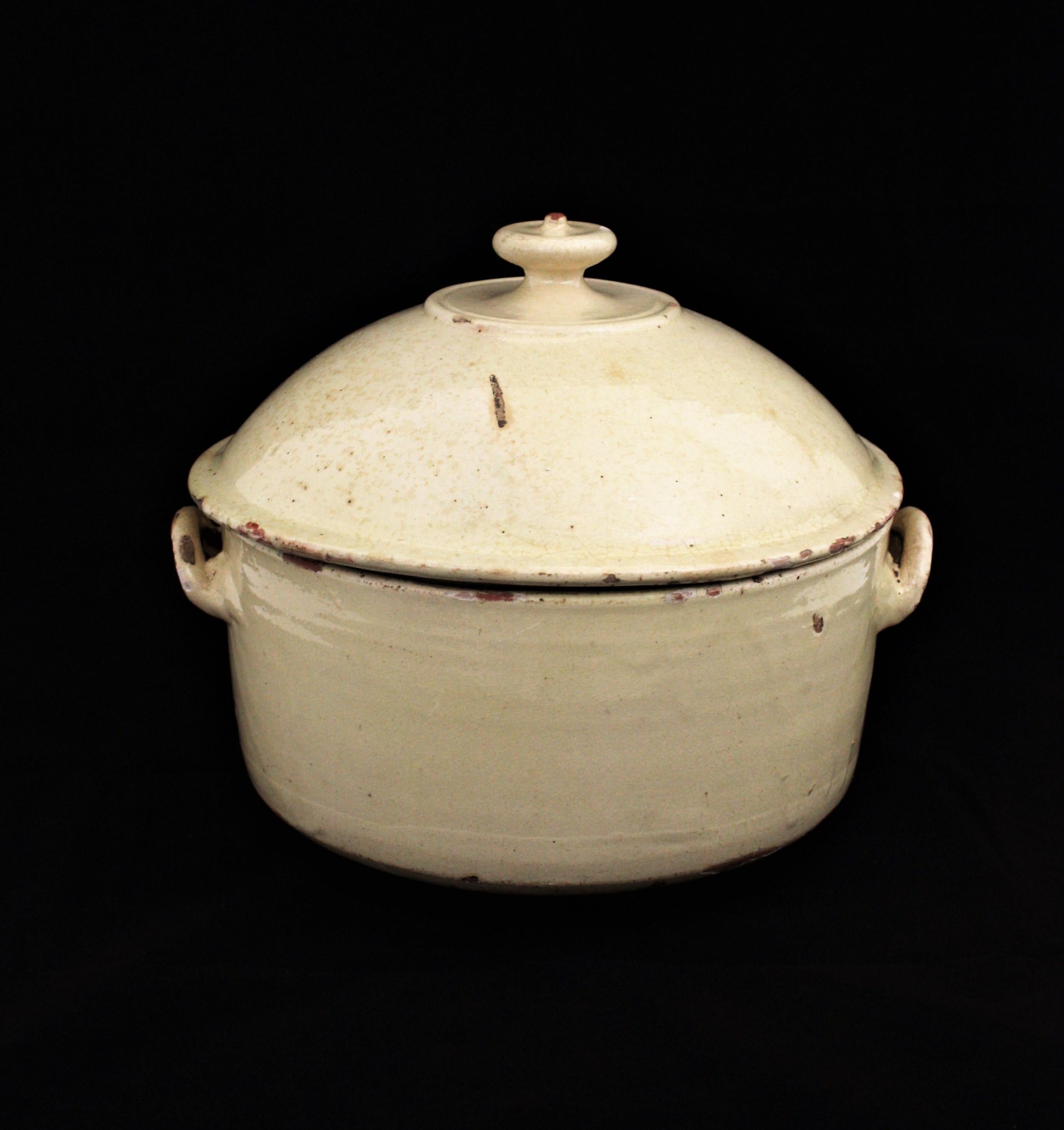 Lovely beige glazed terracotta soup tureen / kitchen pot with handles, France, 19th century.
This French Provincial tureen will be a nice accent to any countryside house kitchen. Beautiful also in any contemporary or classical ambiance.
It can be