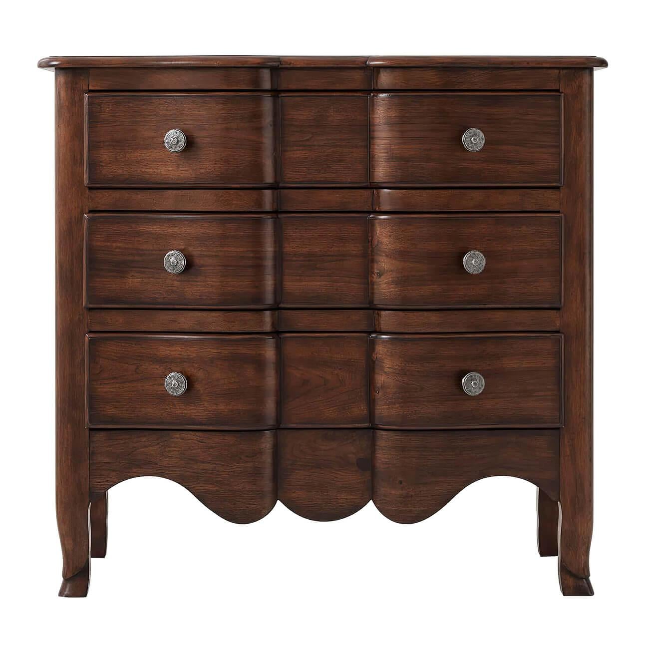 A French Provincial three-drawer serpentine walnut commode with a molded serpentine form top, shaped serpentine drawers with antiqued pewter handles, paneled sides, a scalloped apron, and hoof feet. 

Dimensions: 36
