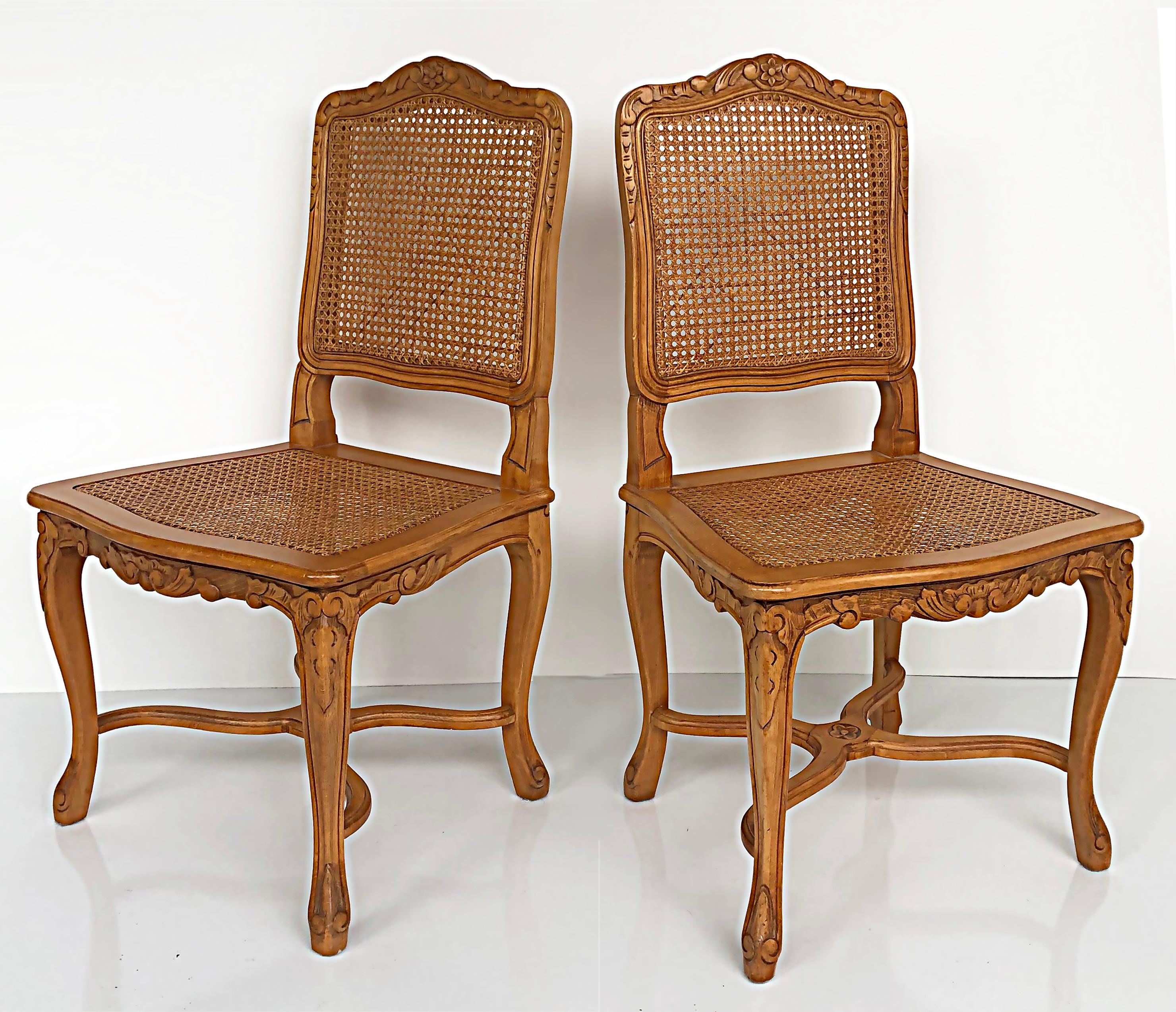 French provincial caned, carved dining chairs with seat cushions, set of eight

Offered for sale is a set of eight French provincial caned and carved dining chairs in a Louis XVI style. The set of side chairs has caned seats and back panels on