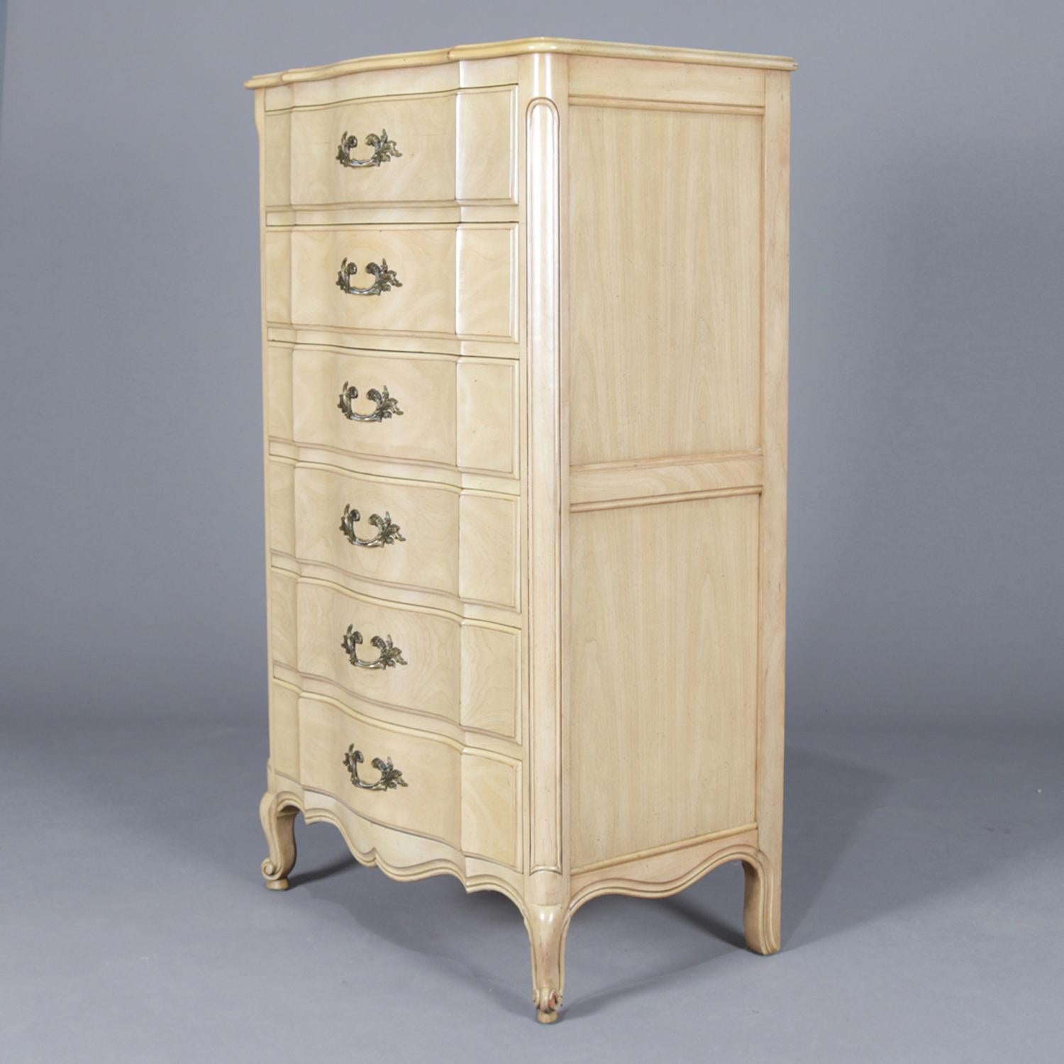 A vintage French Provincial style high chests of drawers by John Widdicomb feature serpentine fronts, six drawers and is raised on cabriole legs and with white washed painted finish, cast foliate form pulls throughout, maker brand on drawer