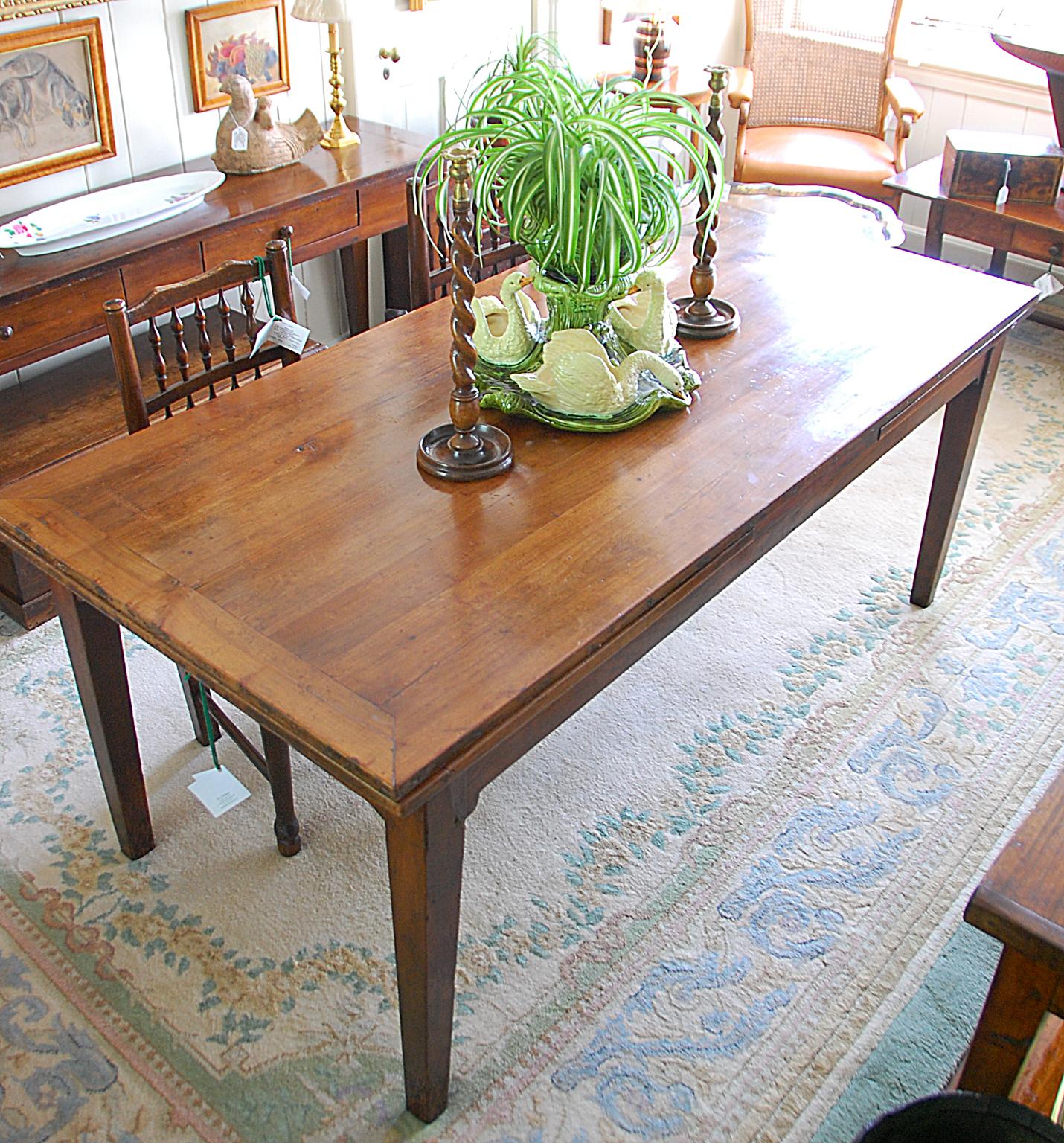 French provincial mid-19th century cherry and chestnut farmhouse extending table with square tapered legs and two drawers. This substantial six foot by 34 1/2 inch extending table has a solid cherry top and frame, the extending leaves are of cherry