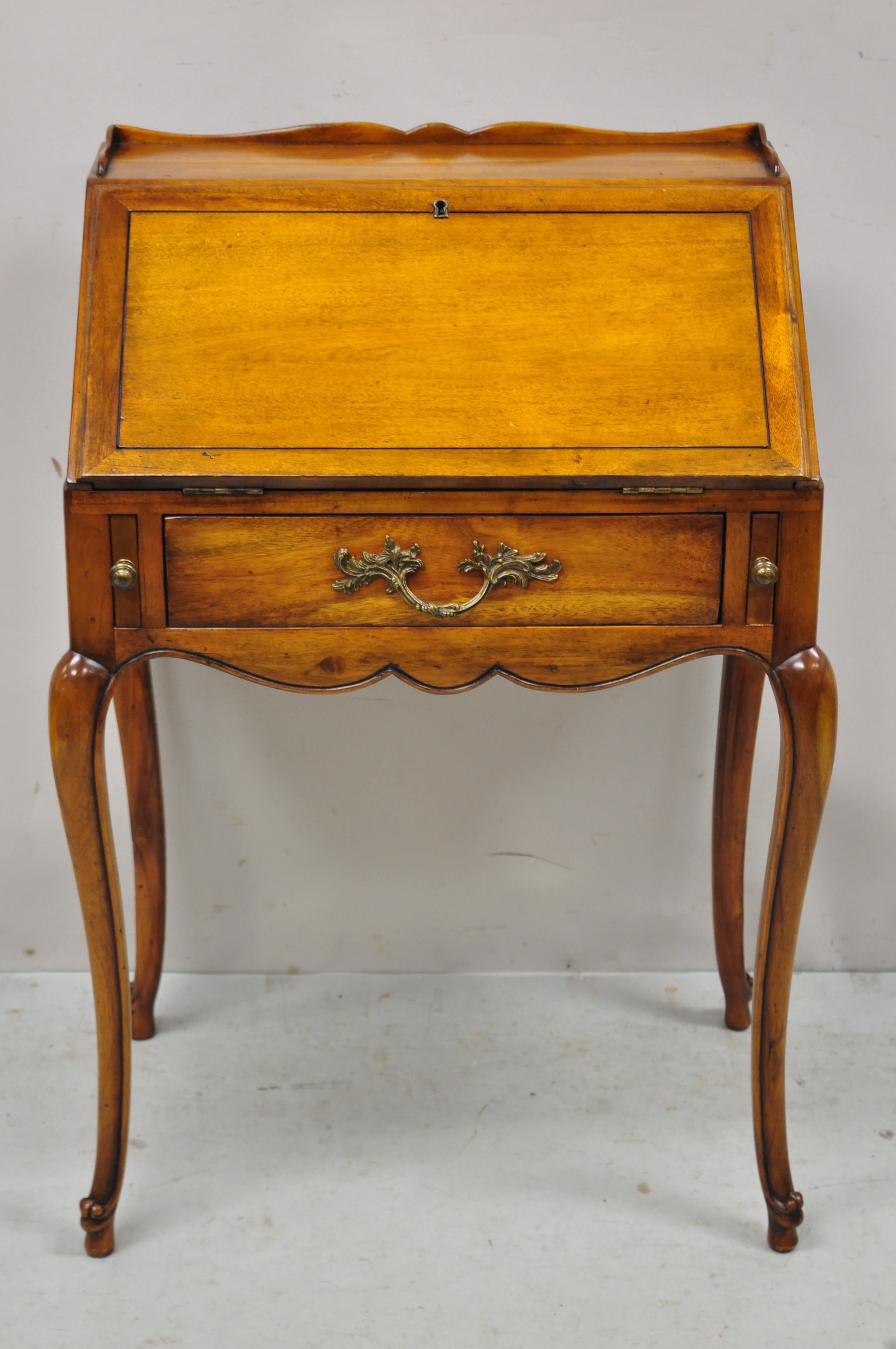 French Provincial style cherry wood fall front small secretary desk attributed to Theodore Alexander. Item features fall front with tooled leather writing surface, fitted interior with drawers, solid wood construction, beautiful wood grain,