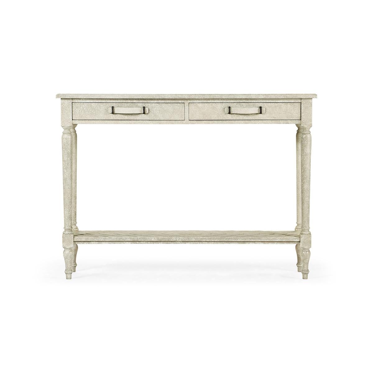 French Provincial Console table, with a heavily distressed whitewash drift finish, this parquet top console has two drawers and under-tier. Bentwood and iron handles contrasting dark geometric inlay to panels. Raised on turned and tapered