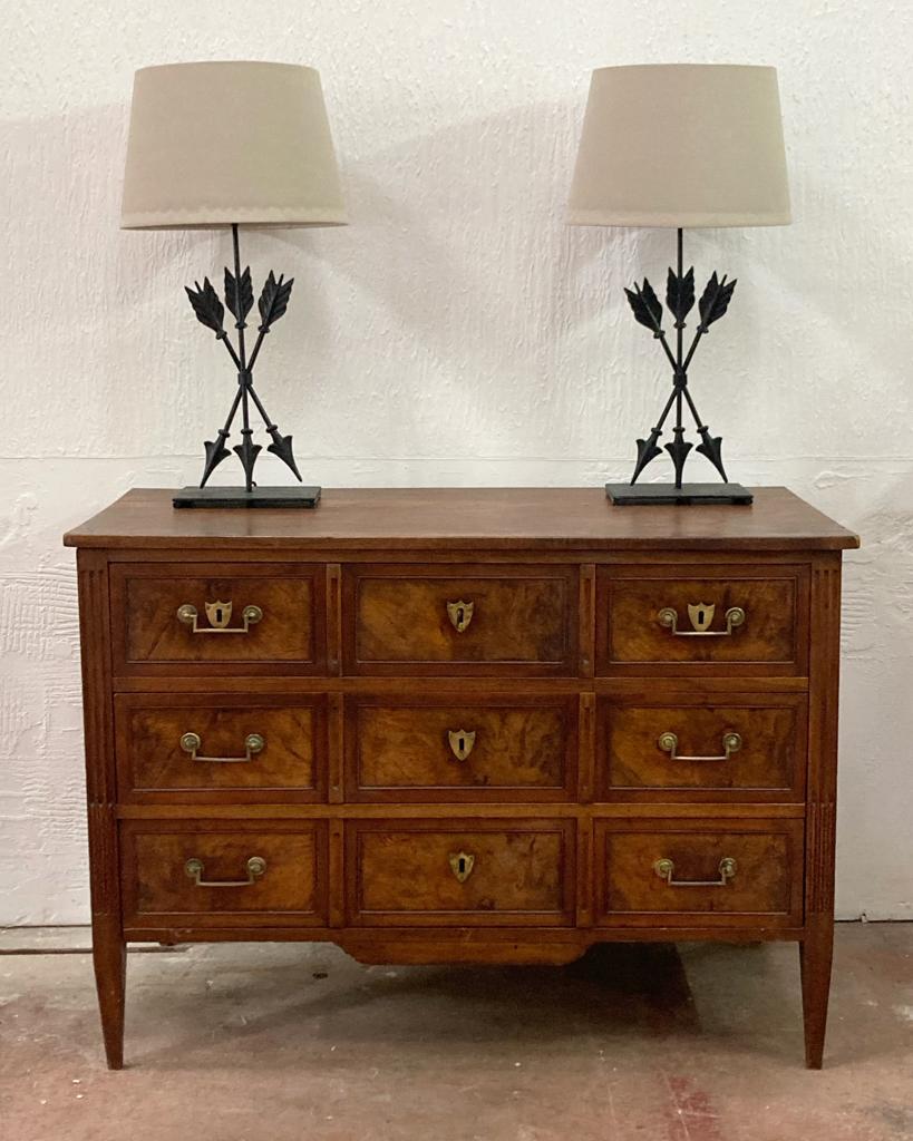 A classically designed French Directoire period commode. Constructed of walnut that’s gained a fantastic patina over time. The chest is a bank of 5 drawers, three small over two long drawers. Shield shaped escutcheons. One key. 
Easy to use brass