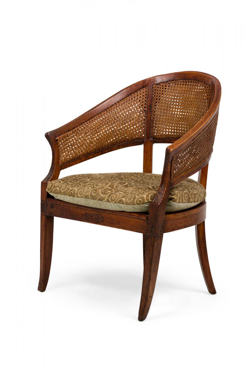 French Provincial (18th Century) wooden armchair with a curved horseshoe-form crest rail supported by 2 back posts dividing into 3 double-caned sections, with a caned seat topped with a removable upholstered two-tone green spiral patterned chenile