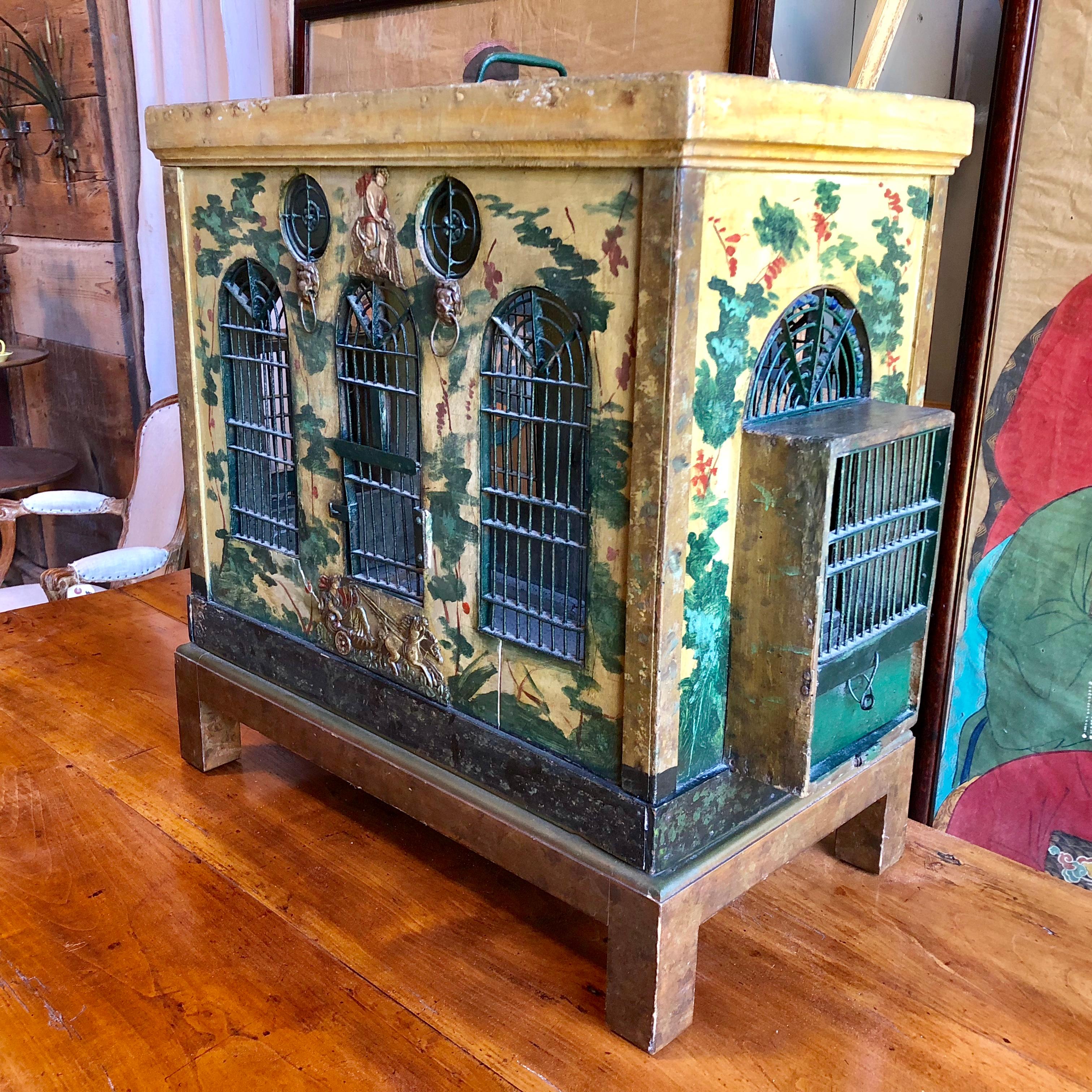 A charming Provincial French folk-art birdcage circa 1850 in wood and wire with painted brass decorative appliques, Palladian style wire windows, bird feeding trays, cobalt blue glass beads, cleaning tray and air vents. Painted with vines and
