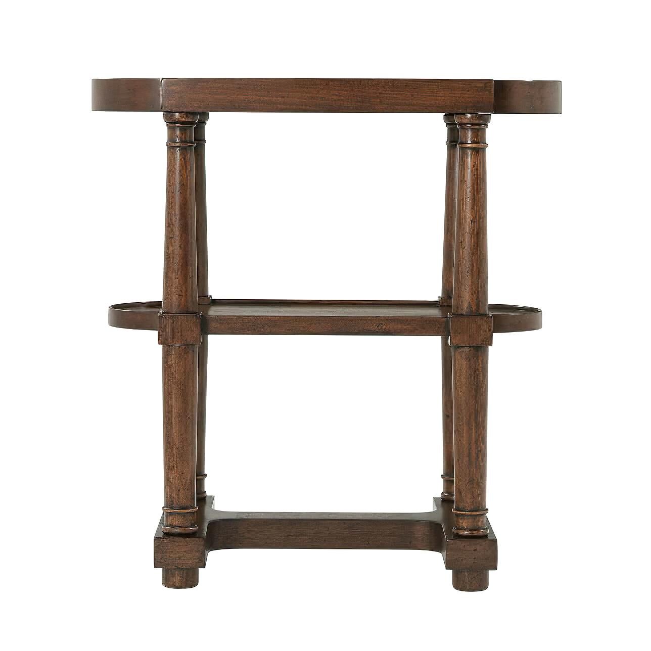 A French Empire style provincial side table of walnut and oak with a shaped dish top, with turned column form supports, a lower shaped shelf and stretcher base.

Dimensions: 25