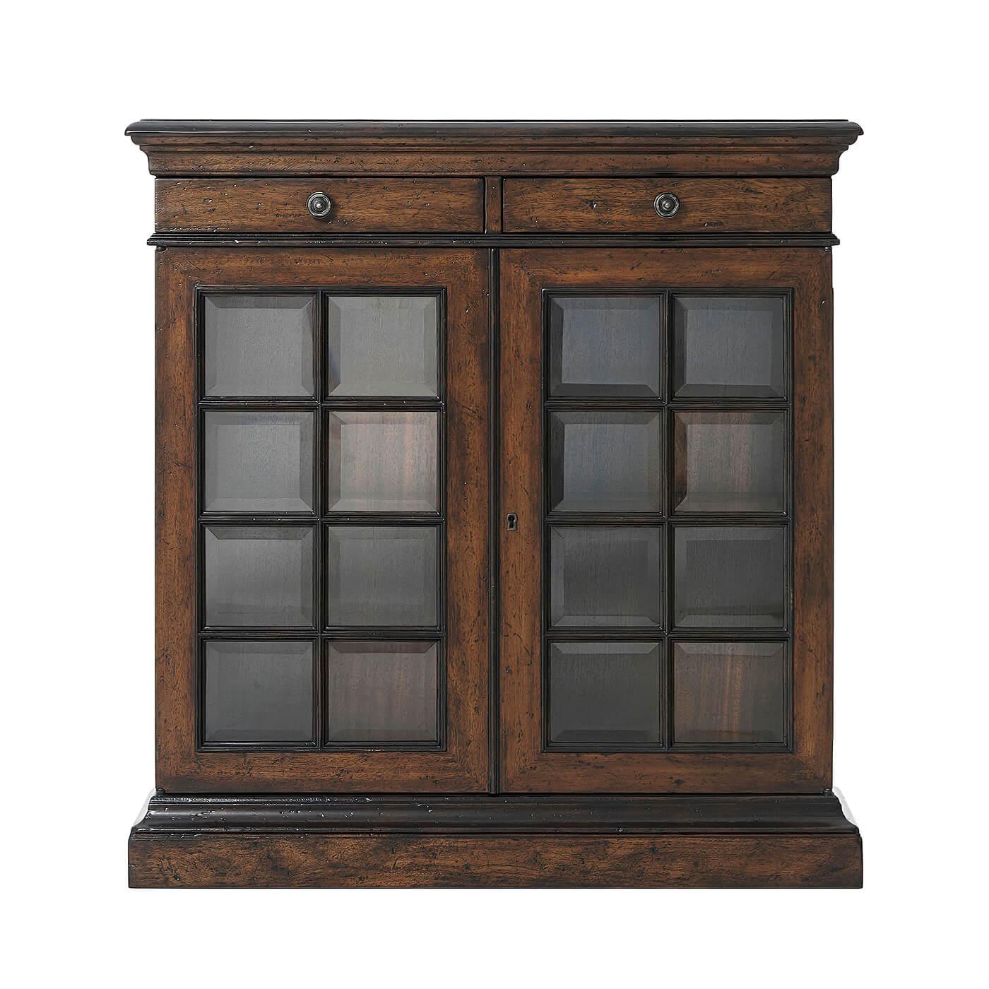 French provincial two door cabinet with a molded edge rectangular parquetry top, two frieze drawers, glazed beveled glass doors a fixed interior shelf on a plinth base.
Dimensions: 34.5