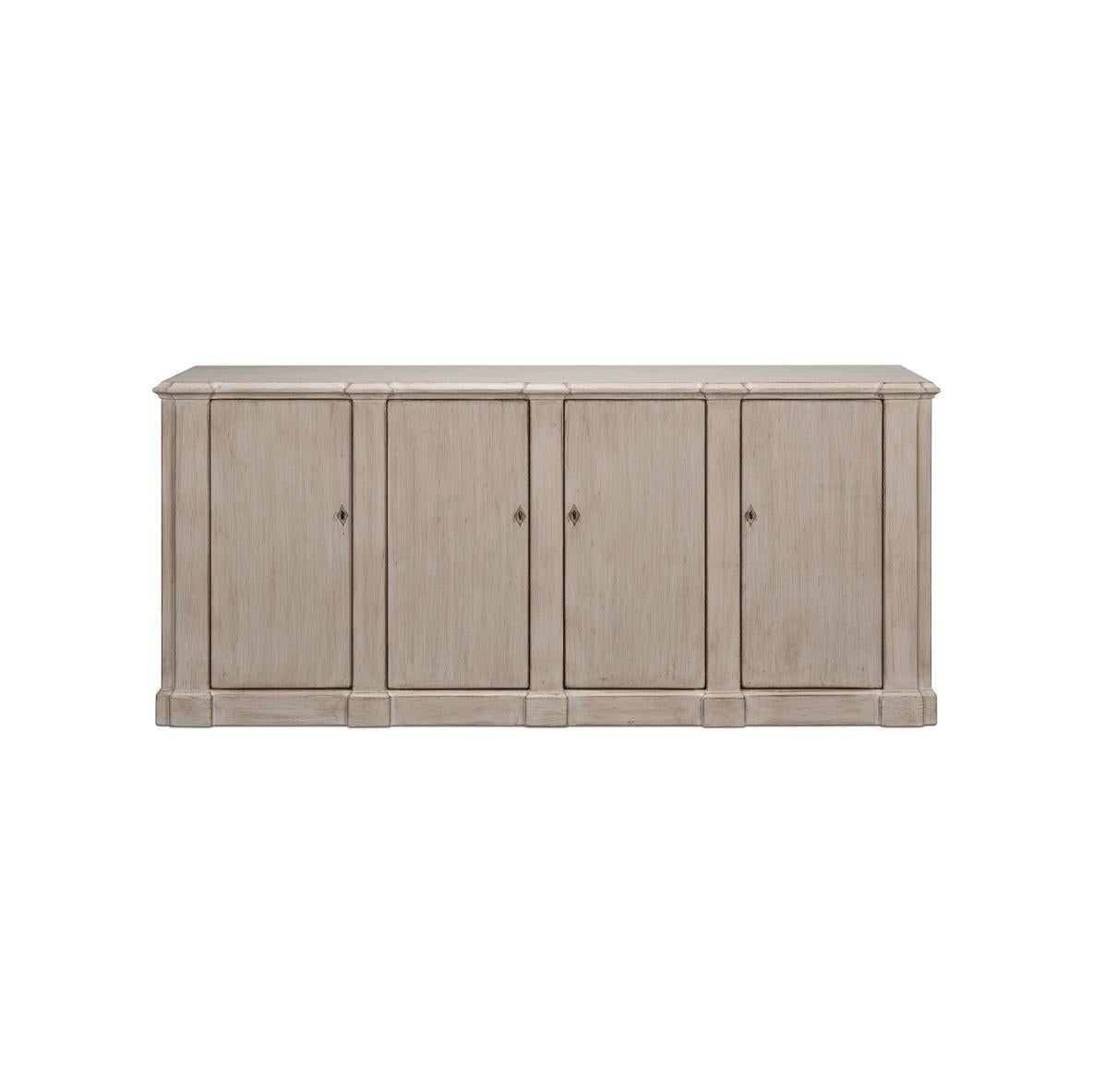 This piece captures the romantic essence of country style with its distressed stone gray finish and vintage charm. The sideboard's generous length, accented by four doors that open to a fitted interior with removable shelves, offers substantial