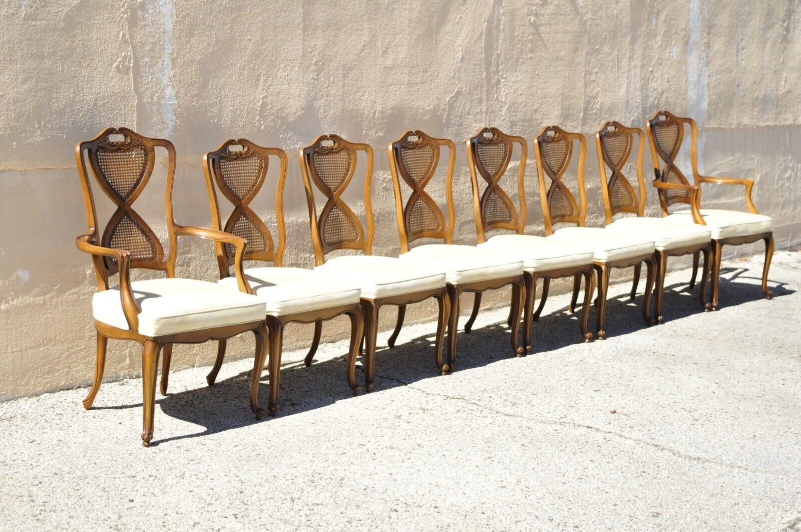 Vintage French provincial Hollywood Regency cane back pretzel twist dining chair - set of 8. Item features (2) armchairs, (6) side chairs, cane back panels, vinyl upholstered seats, pretzel twist carved backs, solid wood frames, cabriole legs. Circa