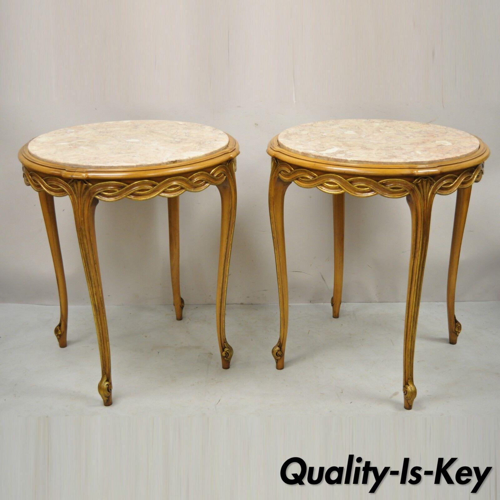 Vintage French Provincial Hollywood Regency round pink marble top side tables - a pair. Item features round pink marble tops, gold gilt accents, woven and shell carved skirt, solid wood frames, cabriole legs, very nice vintage pair. Circa Mid 20th