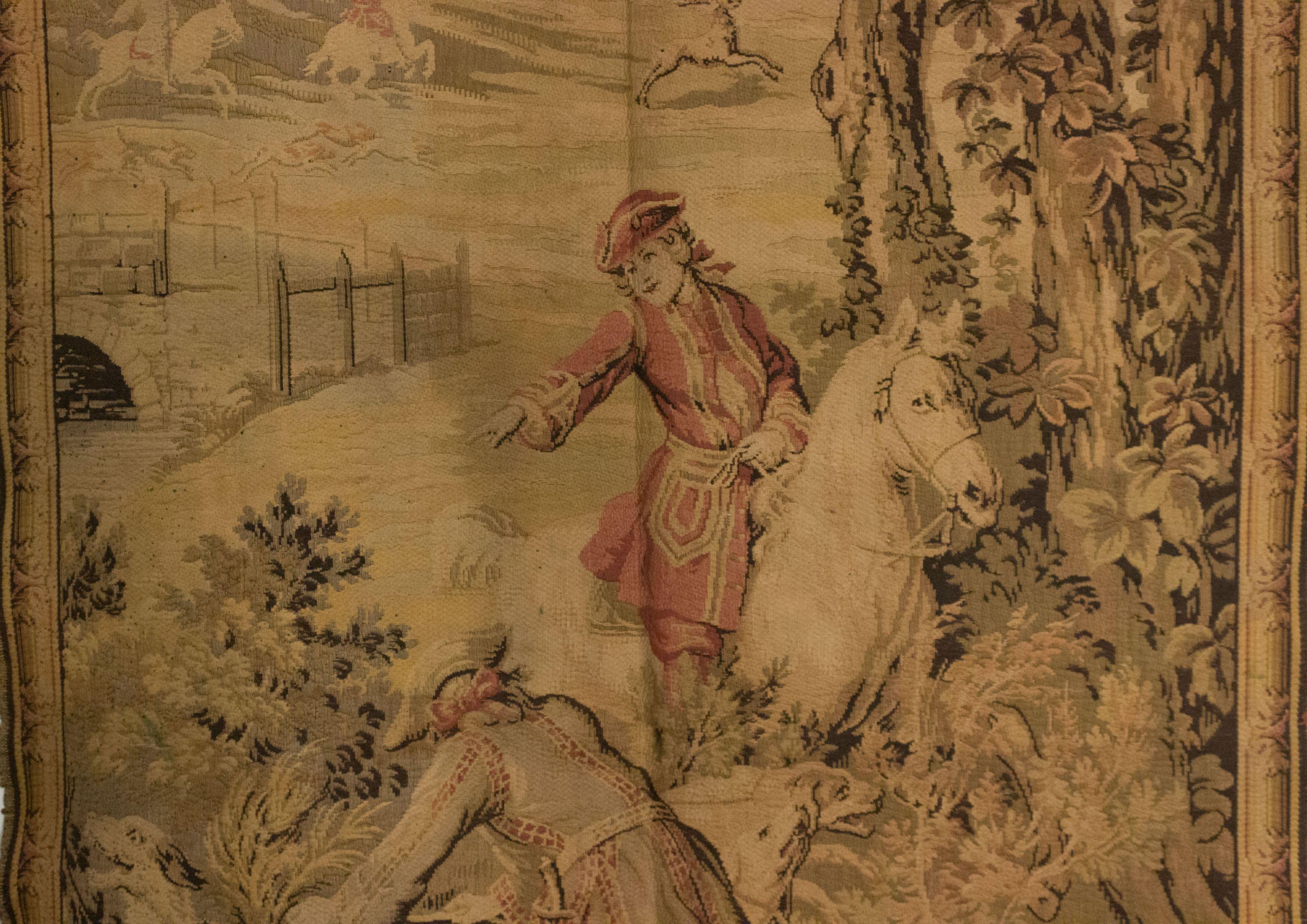 French Provincial (20th Century) vertical woven tapestry of man on horse with dogs and border on 3 sides.
 