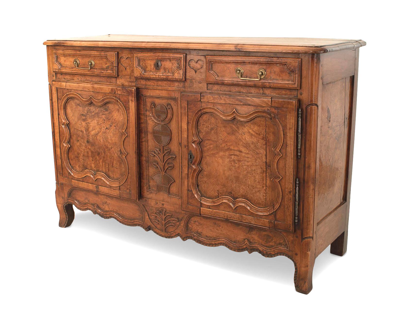 French Provincial Louis XV (18th Century) walnut commode with 2 doors having burl walnut panels separated by a carved center panel under 3 drawers.
