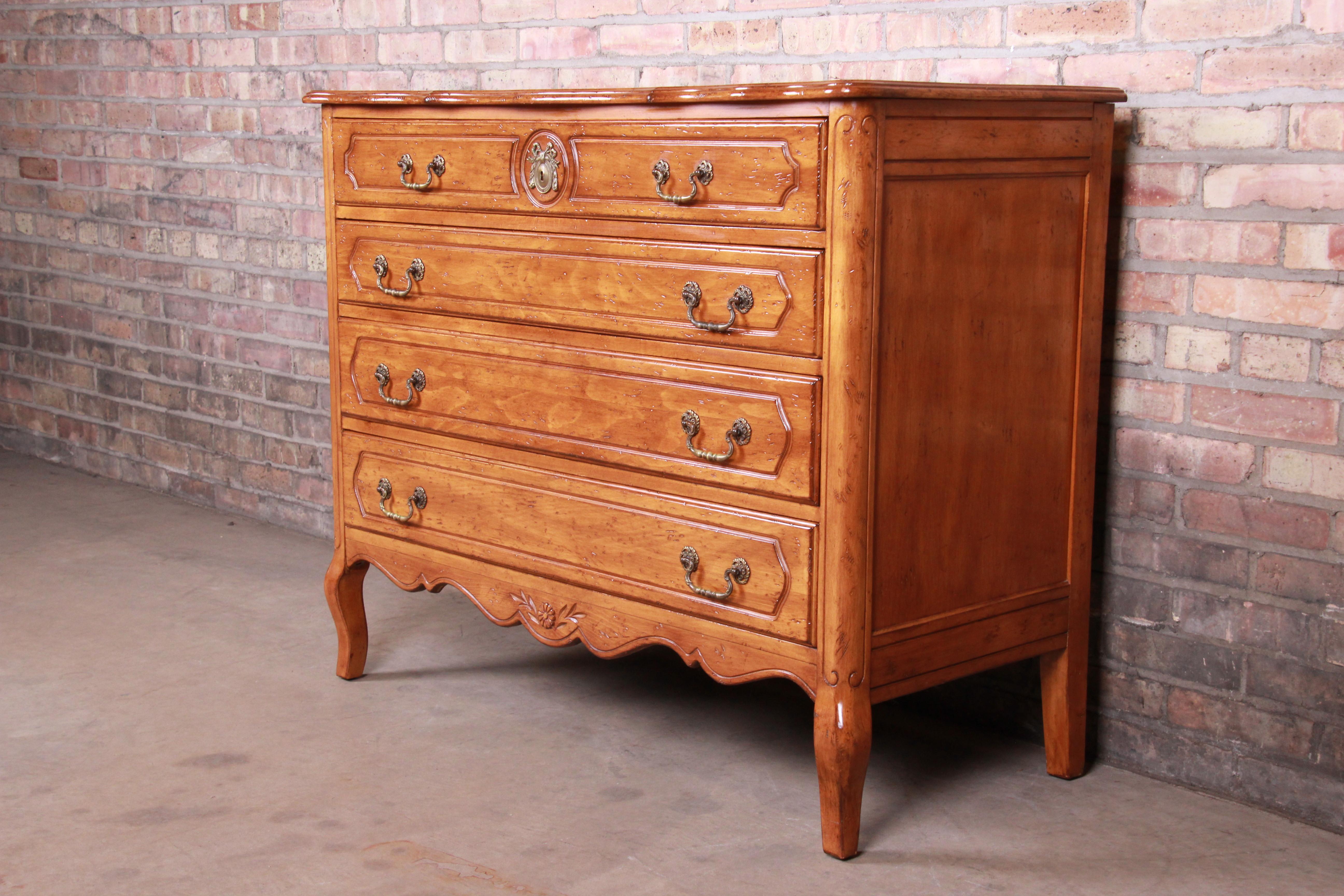 A gorgeous French Provincial Louis XV carved fruitwood four-drawer dresser or chest of drawers,

mid-20th century

Measures: 44.25