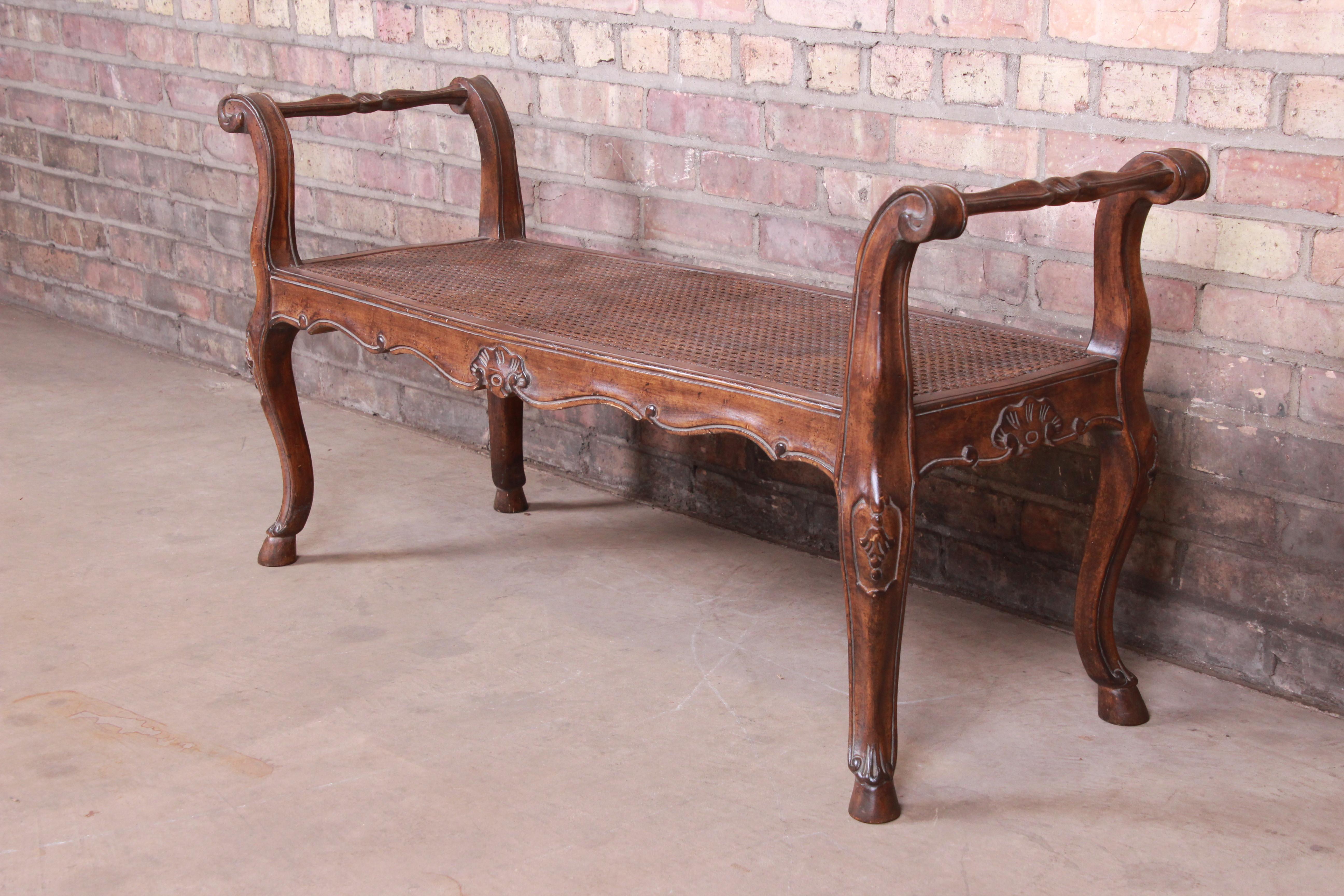 A gorgeous French Provincial Louis XV style window bench or bed bench

Mid-20th century

Carved walnut, with cane seating.

Measures: 43.5