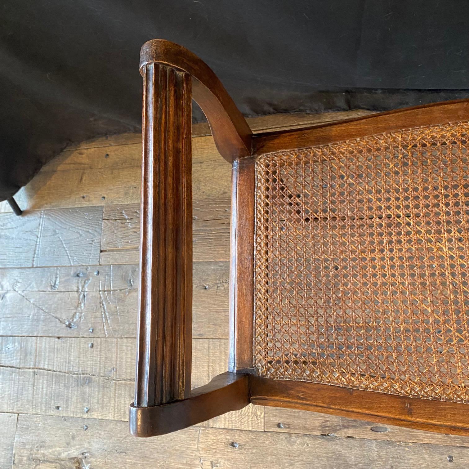 Early 20th Century French Provincial Louis XV Carved Walnut Bench or Ottoman with Caning For Sale