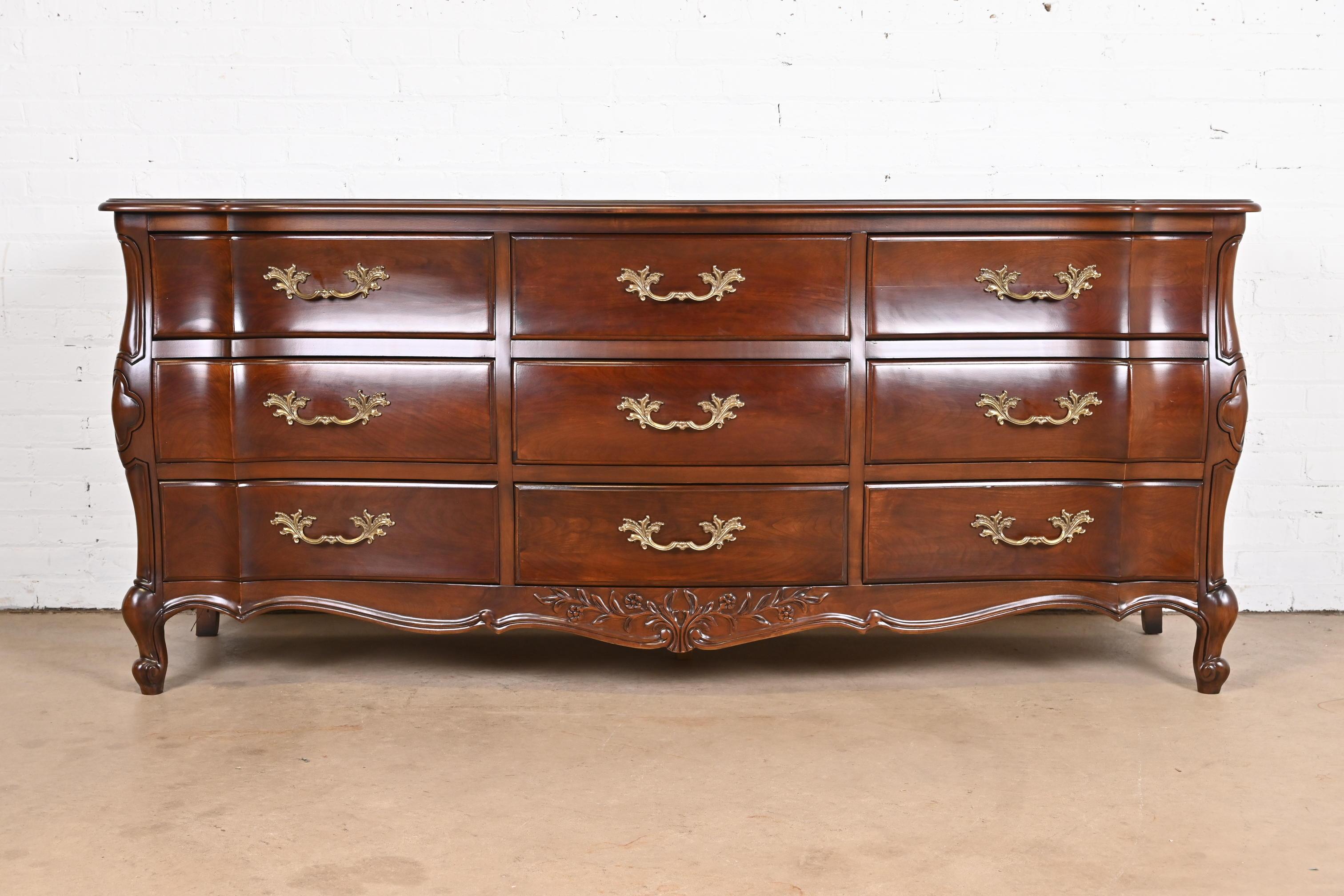 An exceptional French Provincial Louis XV style nine-drawer dresser or credenza

By White Furniture

USA, Late 20th Century

Carved cherry wood, with original brass hardware.

Measures: 75.5