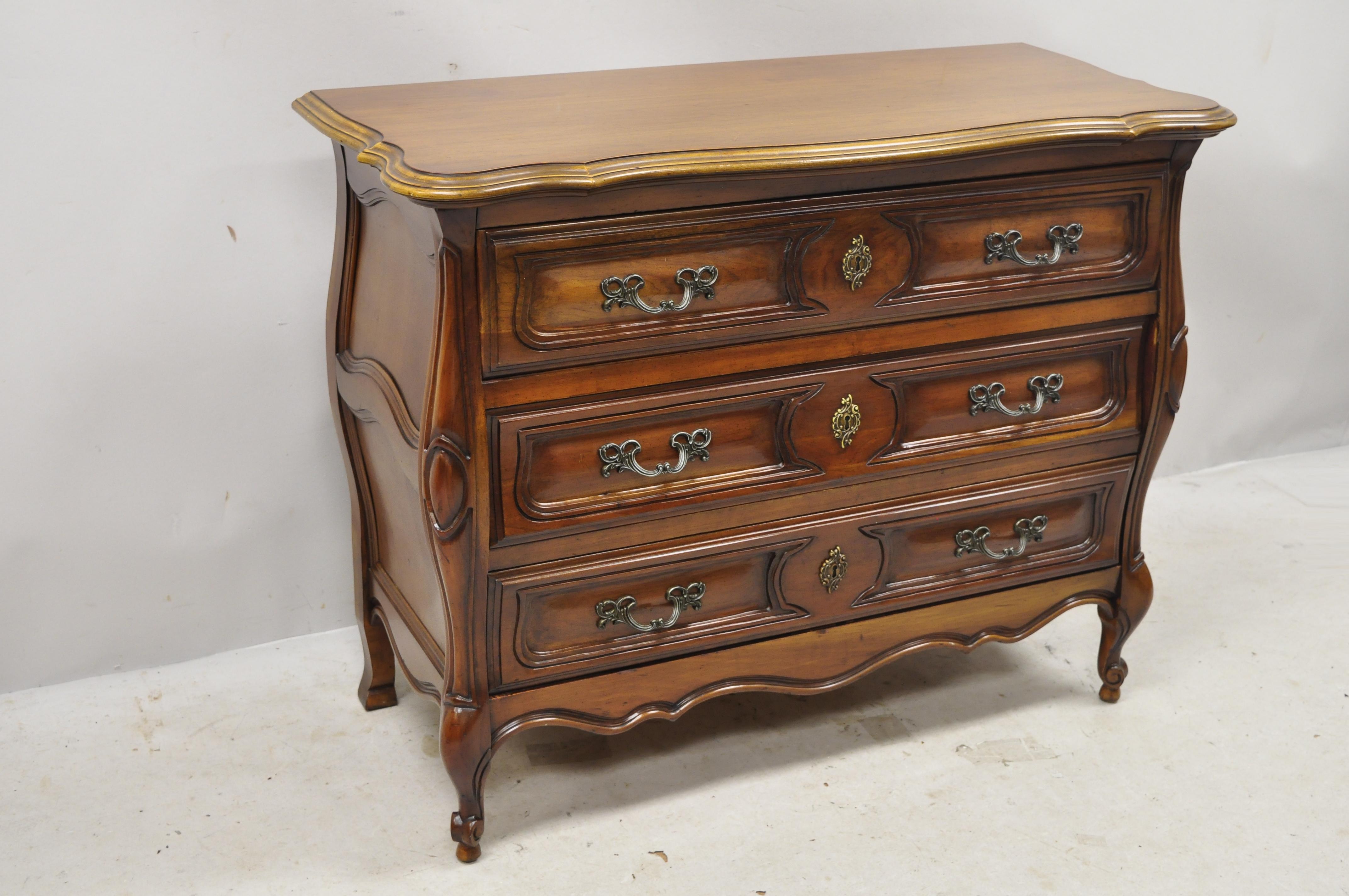 French Provincial Louis XV Country style Sienna cherry bombe commode chest dresser. Item features panel carved sides, solid wood construction, beautiful wood grain, nicely carved details, 3 dovetailed drawers, cabriole legs, solid brass hardware,