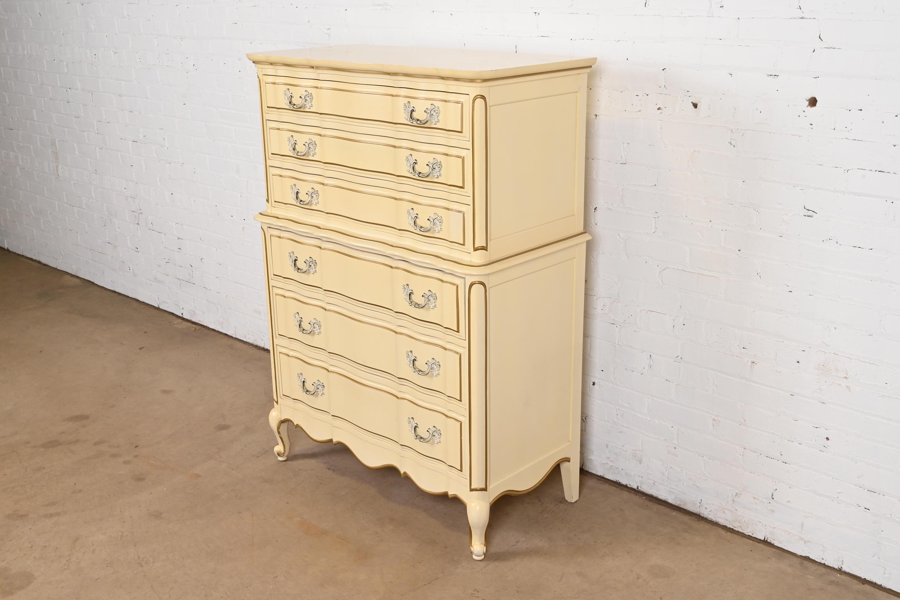 A gorgeous French Rococo or French Provincial Louis XV style highboy dresser

In the manner of John Widdicomb

USA, 1950s

Carved cherry wood, with original cream lacquered and gold gilt finish, and painted brass hardware.

Measures: 37.63