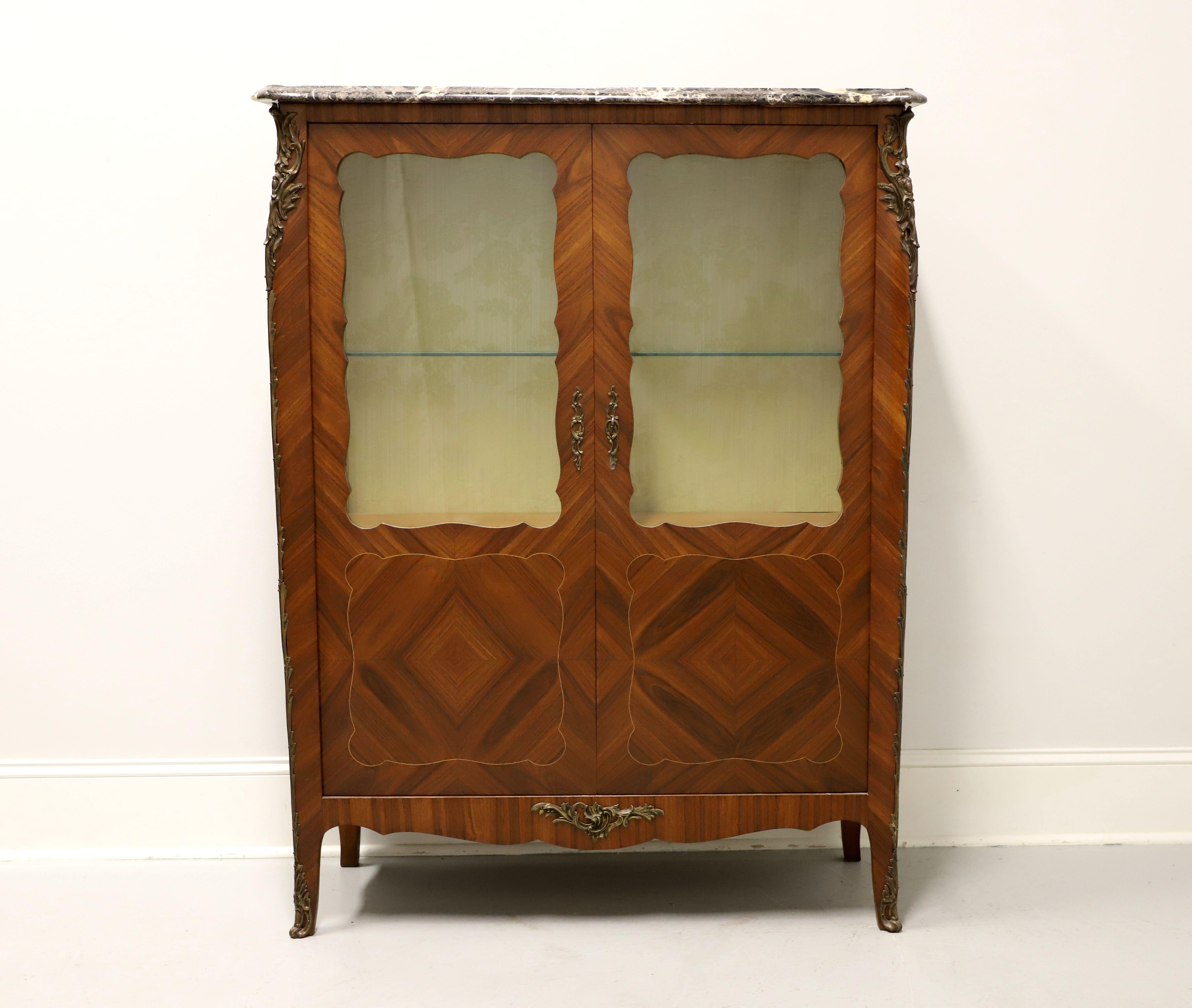 Here is an exquisite vitrine in the French Provincial, Louis XV style. Age unknown. Made from walnut with kingwood inlays and crotch veneers. Bronze ormolu mounts, marble top. Upper portion features glass doors with one glass shelf, inside is