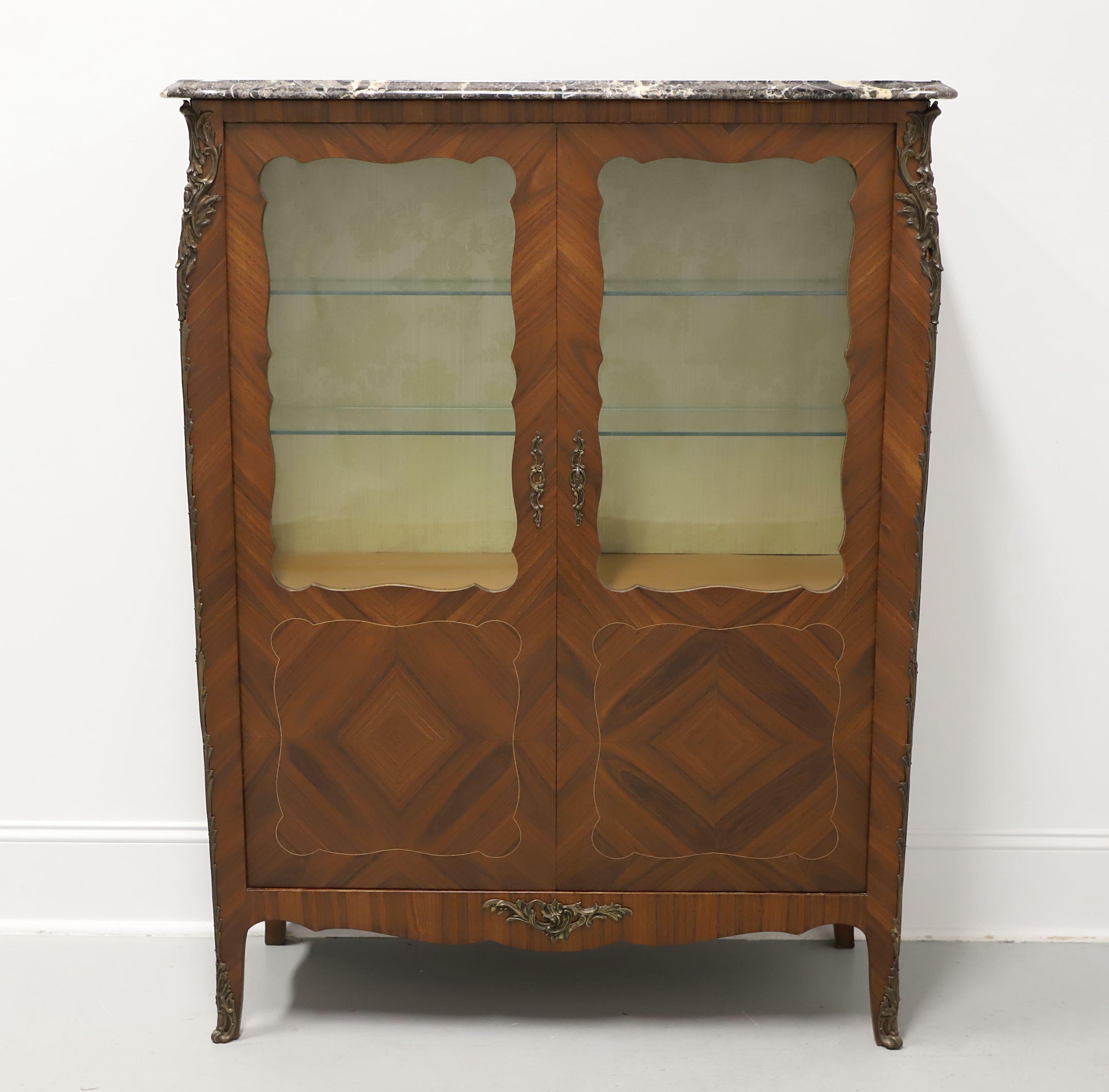 An exquisite reproduction of a French Provincial Louis XV style vitrine, unbranded. Walnut with kingwood inlays & crotch veneers, bronze ormolu mounts, and a marble top. Behind two upper glass & lower solid doors is an upper visible display area