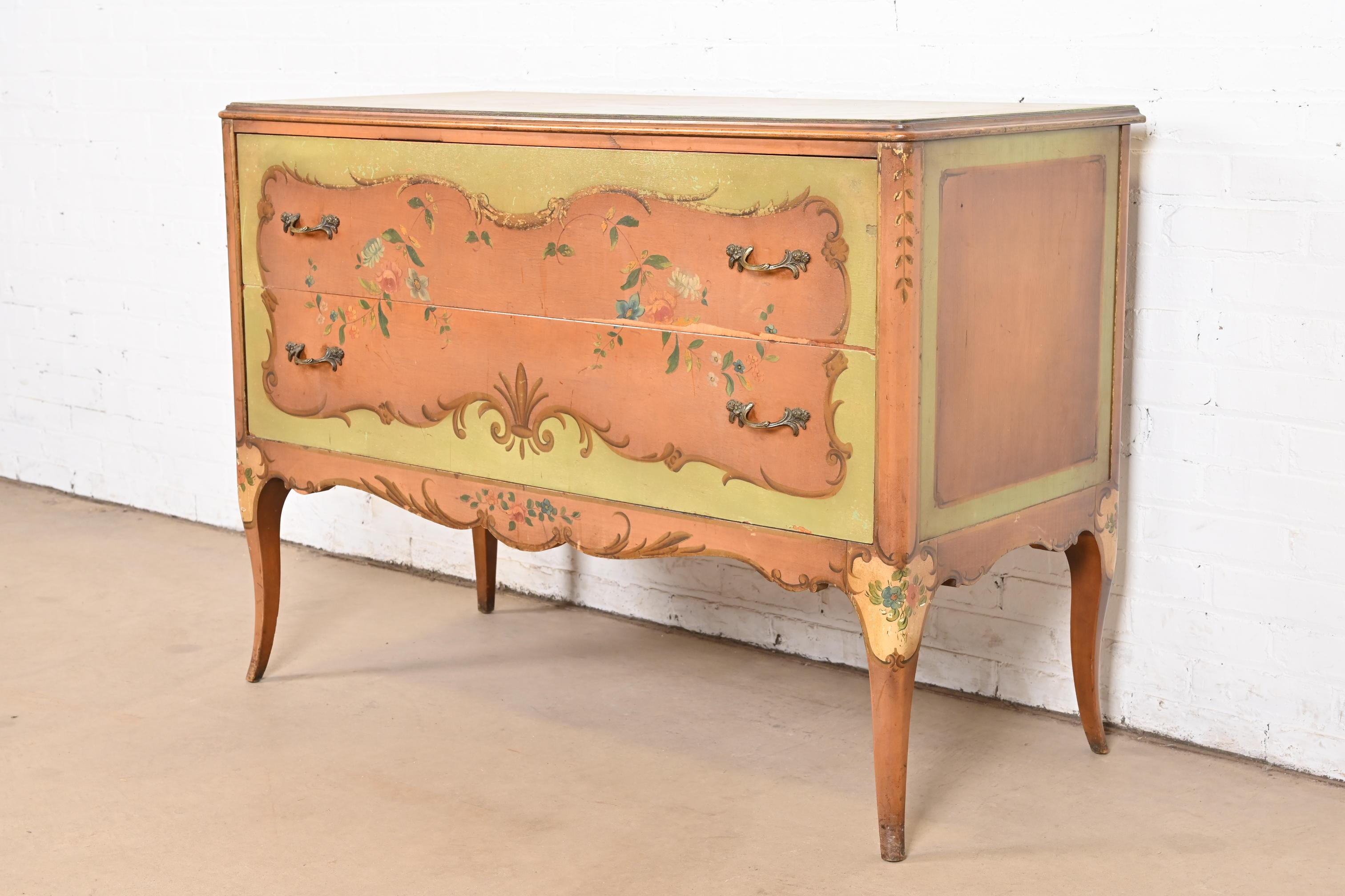 A gorgeous French Provincial Louis XV style two drawer dresser or chest of drawers

By Robert W. Irwin Co.

USA, Circa 1920s

Walnut, with original hand painted floral design, and original brass hardware.

Measures: 48